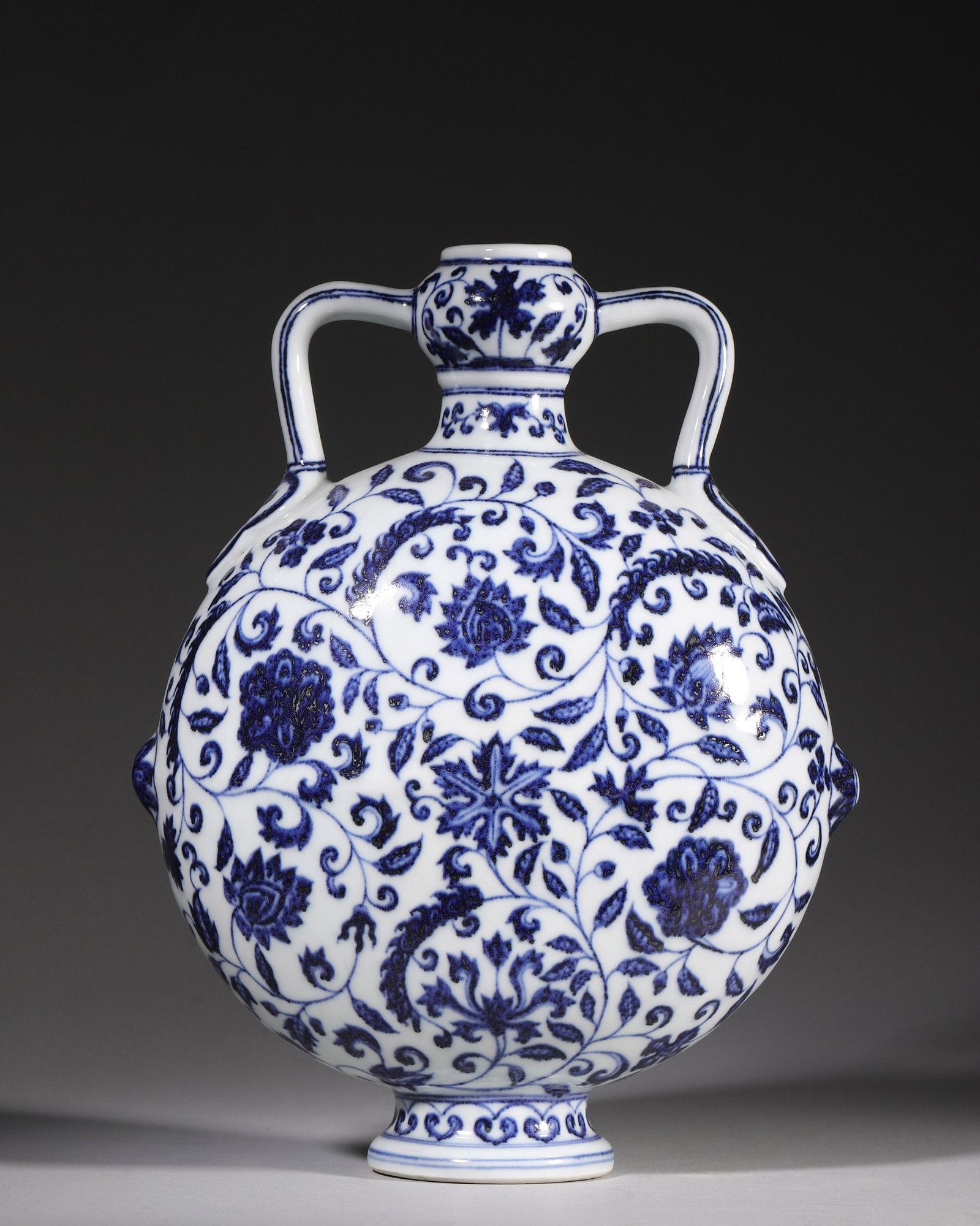 A BLUE AND WHITE MOON FLASK WITH FLORAL SCROLLS, XUANDE PERIOD MING DYNASTY (1 of 9)