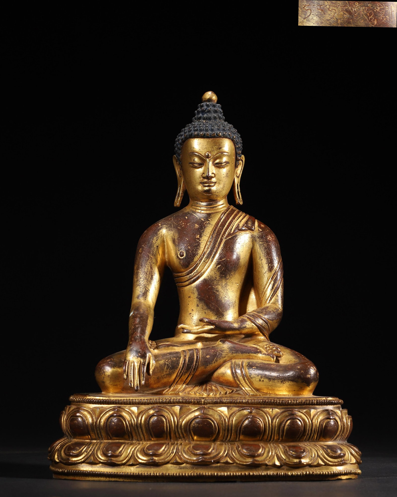 IMPERIAL COMMISSIONED GILT-BRONZE FIGURE OF SHAKYAMUNI BUDDHA, MING DYNASTY: 8.66" x 5.91" x 11.42" inches (22.0 cm x 15.0 cm x 29.0 cm) (Main) | Weight: 9.47 lbs (4296.0 g)A fine imperial gilt-bronze figure of Shakyamuni Buddha, Ming Dynasty. Exquisitely cast with rich gildin