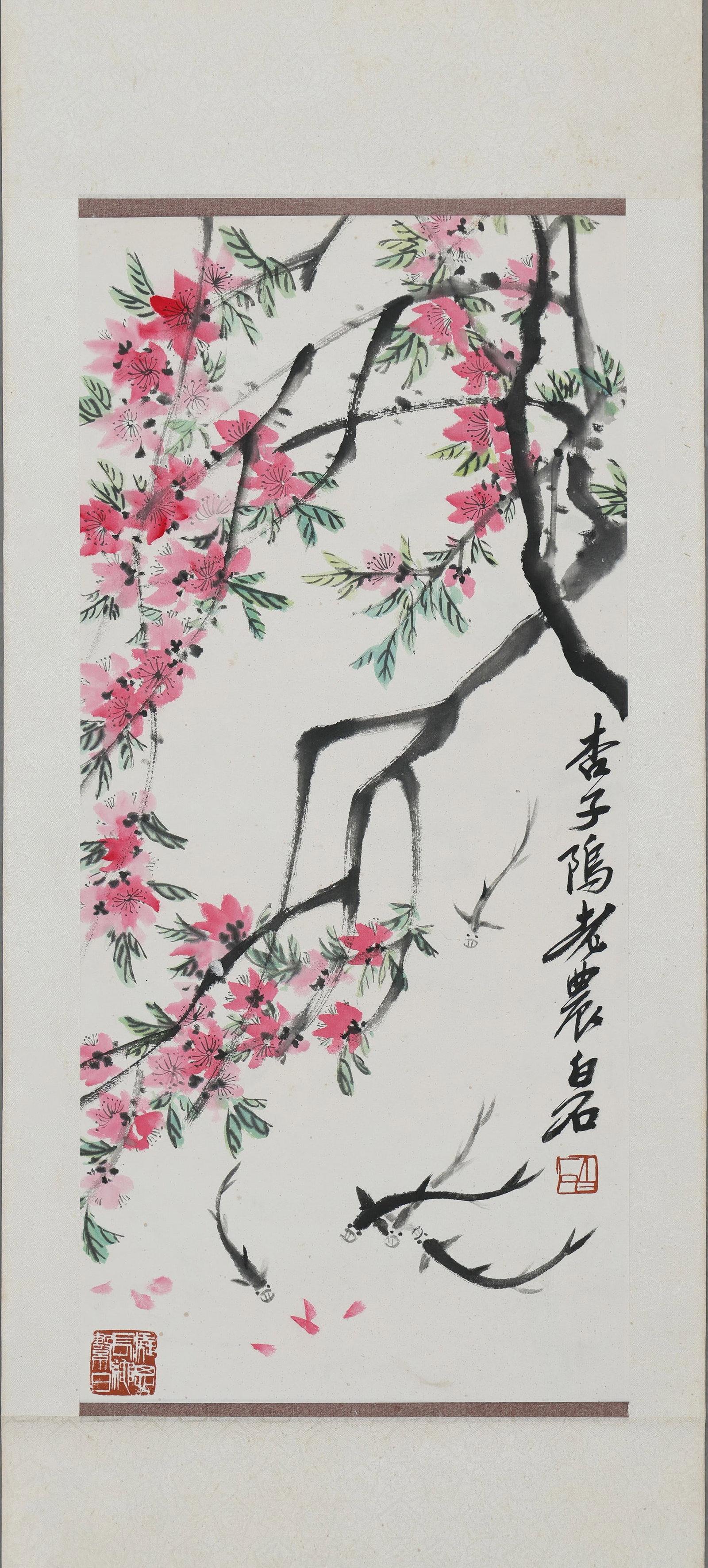 An Ink and Color Painting "Peach Blossoms and Fish" by Qi Baishi, Hanging Scroll: Painting Core SizeL 65cm (25.59 in); W 30cm (11.81 in)This hanging scroll, Peach Blossoms and Fish by Qi Baishi, depicts spring scenery with vibrant peach blossoms and swimming fish in freehand brushw