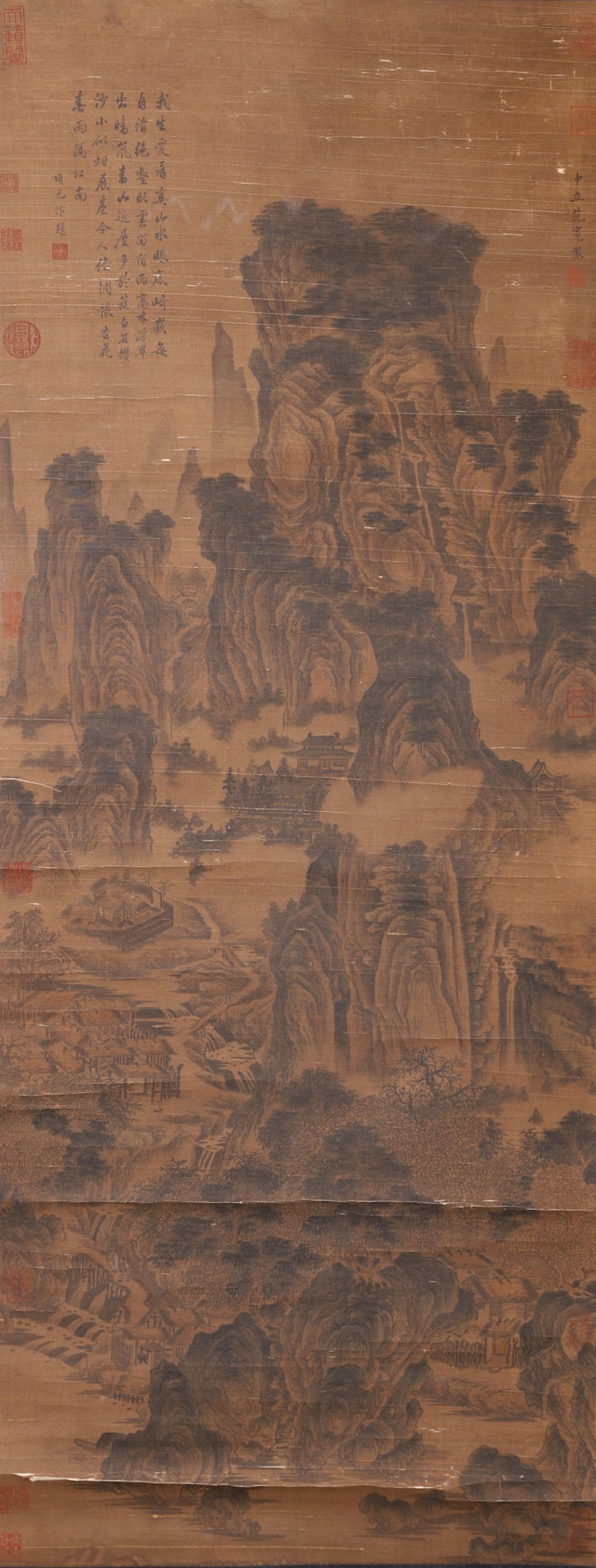 A Silk Ink Landscape Painting Attributed to Fan Kuan, Song Dynasty: Core L 130cm (51.18 in); Core W 50cm (19.69 in)An ink landscape painting on silk attributed to Fan Kuan of the Song Dynasty, depicting towering mountains in panoramic composition. With vigorous brushw