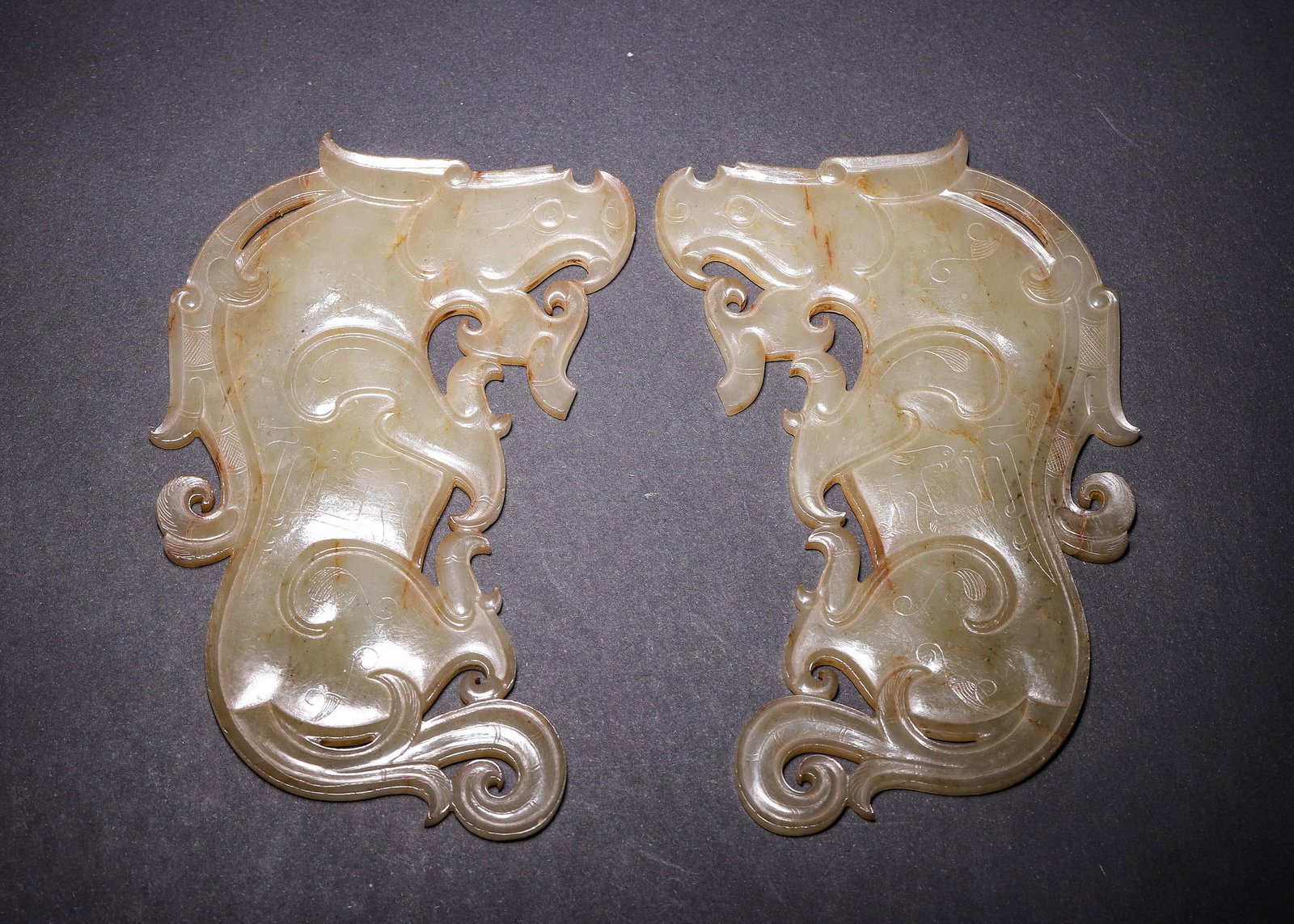 A PAIR OF HETIAN CELADON JADE OPENWORK DRAGON PENDANTS, WARRING STATES PERIOD (1 of 12)