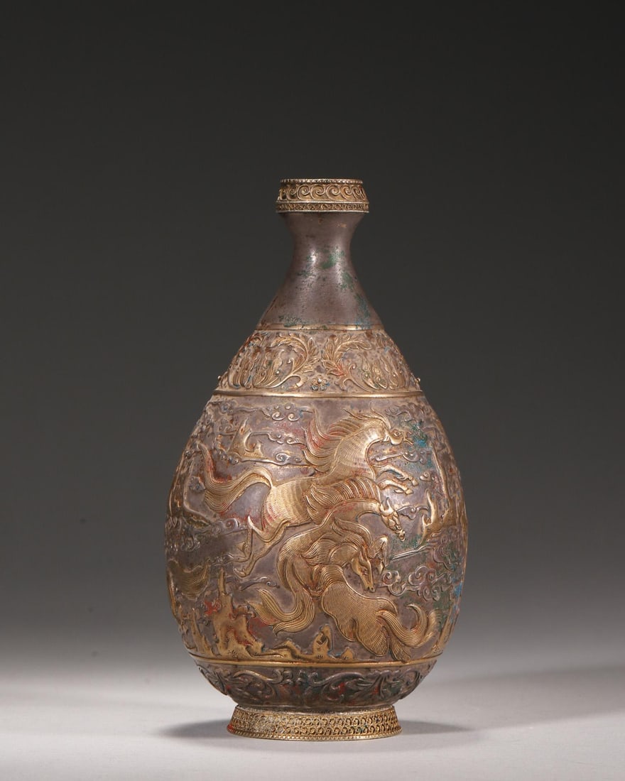 A Silver Partially Gilt Flask with Engraved Heavenly Horses and Cloud Patterns, Tang Dynasty: D 8.0cm (3.15 in); H 16.0cm (6.3 in); Wt 212.0g (0.47 lb)This is a Tang Dynasty silver partially gilt pear-shaped flask. It features exquisitely engraved and gilt patterns of galloping heavenly horses