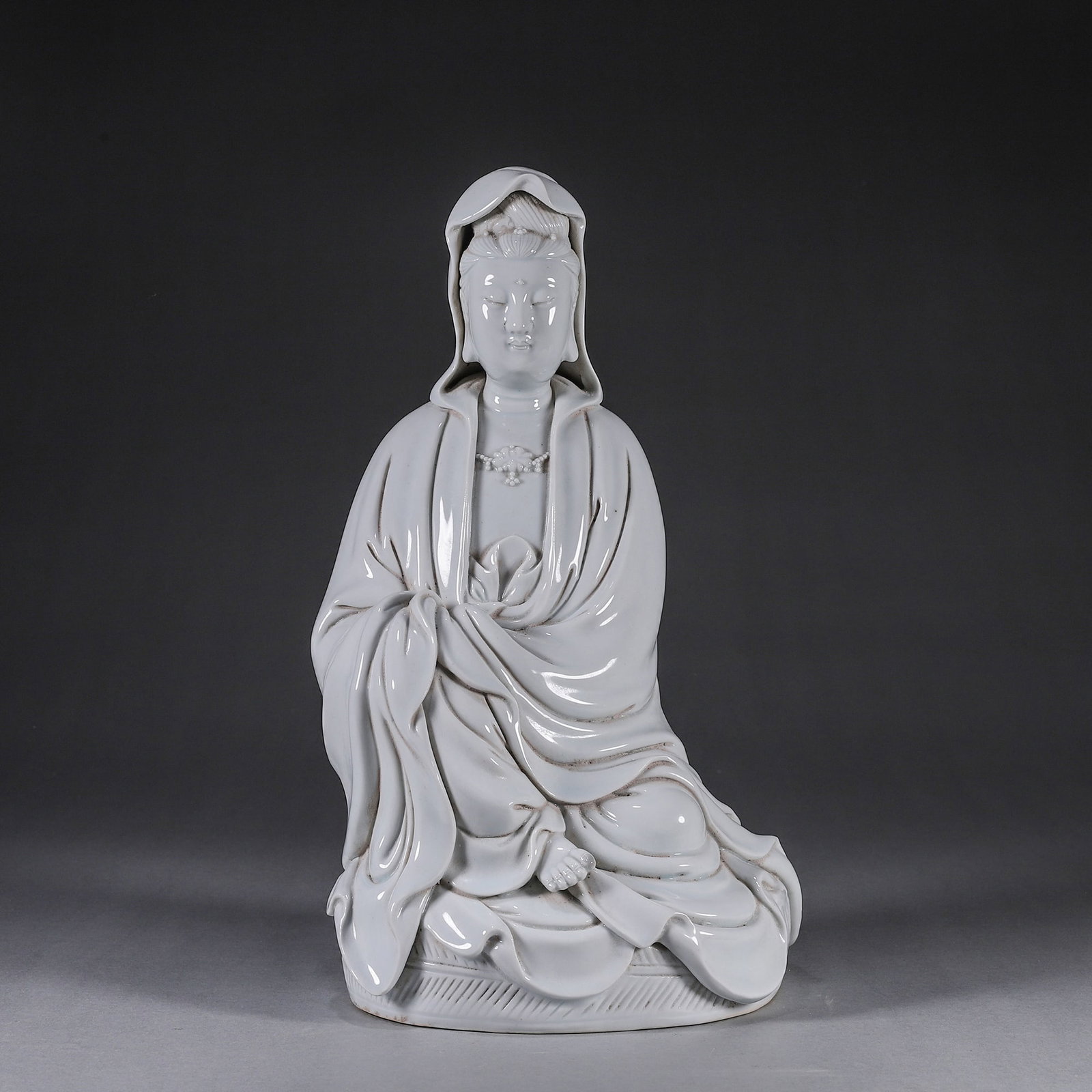 A Dehua Blanc-de-Chine Seated Guanyin, Ming Dynasty (1368-1644), impressed He Chaozong seal mark (1 of 9)