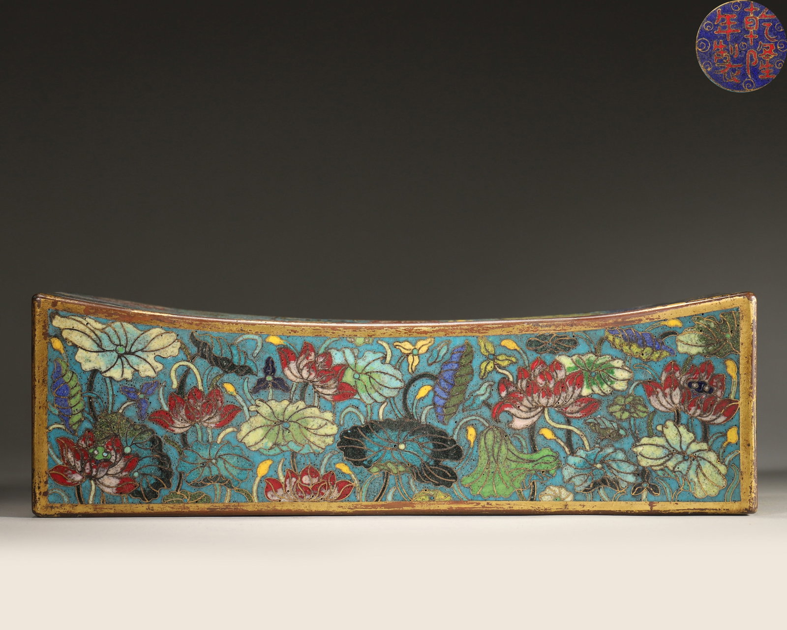 Qing Dynasty, Qianlong Imperial-Made, Cloisonne Enamel on Copper Pillow with Lotus Pond and Mandarin: Length 29.0cm (11.42in), Width 12.0cm (4.72in), Height 9.0cm (3.54in), Weight 1808.0g (3.99lb)Copper body with gilding, peacock blue background fully decorated with lotus pond, mandarin ducks and lotu