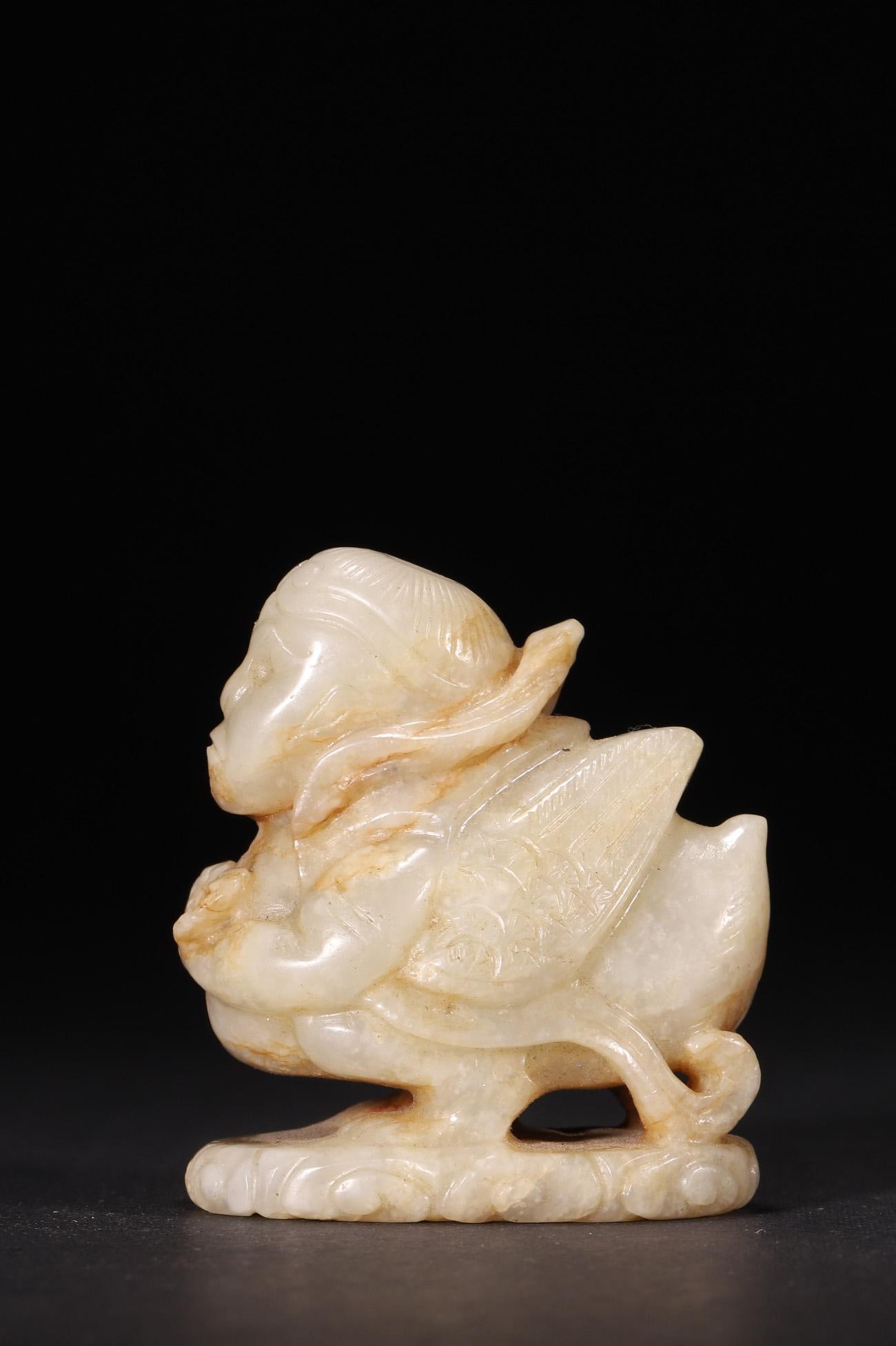 A - Hetian Jade Garuda (Golden-winged Bird) Statue, Liao-Jin Period: L 5cm (1.97 in); H 5cm (1.97 in)Carved from Hetian jade with natural patina, this Liao-Jin period Garuda statue features a human-headed bird form, detailed wings, and cloud patterns on the base. It is