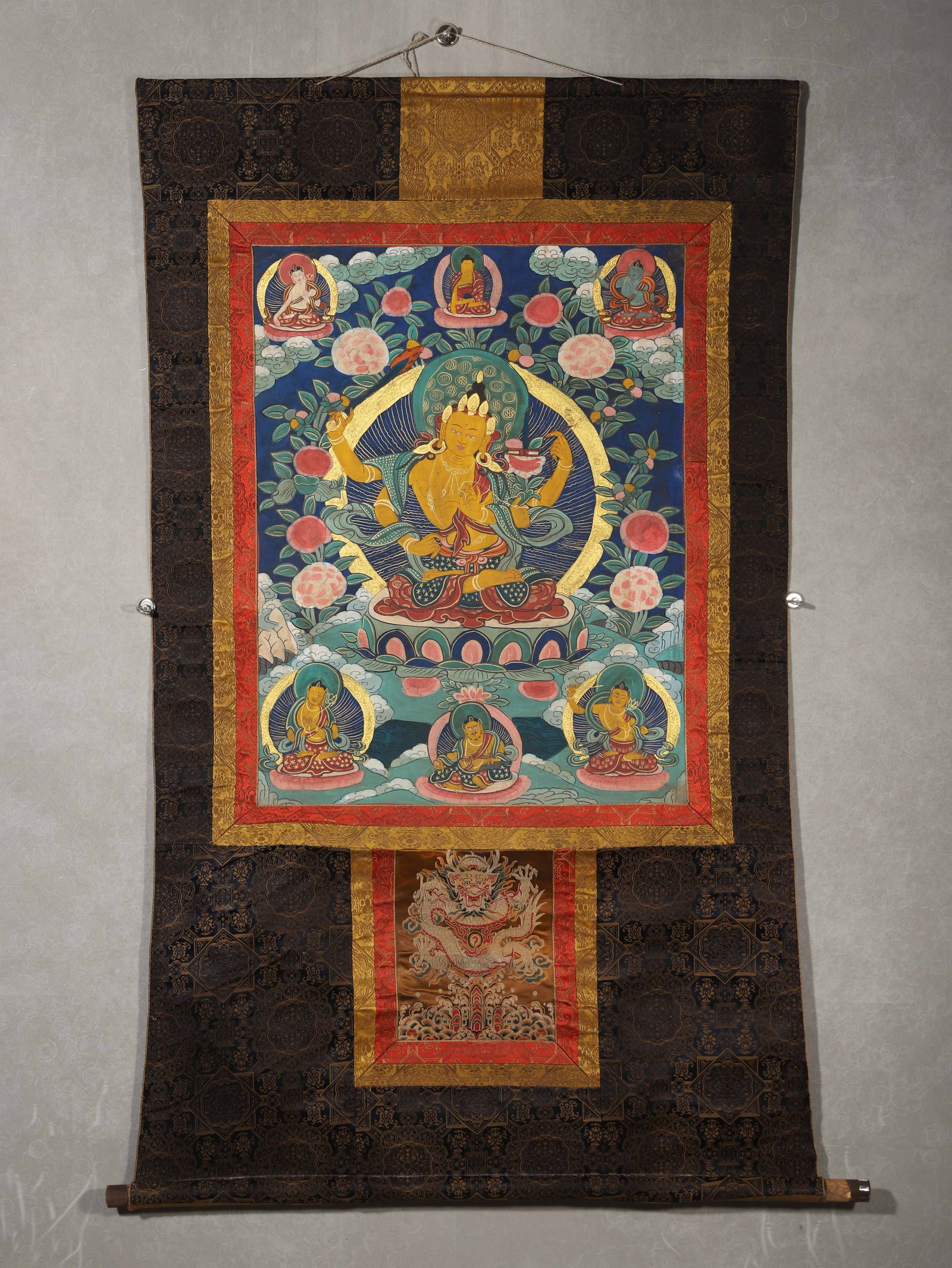 QING DYNASTY (18TH-19TH CENTURY), A TIBETAN THANGKA OF FOUR-ARMED MANJUSHRI: 30.31" x 23.23" inches (77.0 cm x 59.0 cm) (Main)Painted with mineral pigments on cloth, this thangka depicts the golden Four-Armed Manjushri seated on a lotus, holding a wisdom sword and scriptures, 