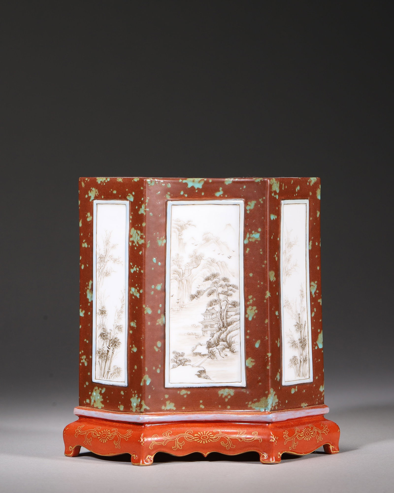 A TWIN RHOMBIC PORCELAIN BRUSH POT WITH INK LANDSCAPE AND BAMBOO PANELS, QIANLONG PERIOD, QING: H 13.00cm (5.12 in); L 13.00cm (5.12 in); W 8.00cm (3.15 in),Qianlong marked twin rhombic brush pot with rust red speckled glaze. Four white panels painted ink landscape and bamboo scenery, matched co