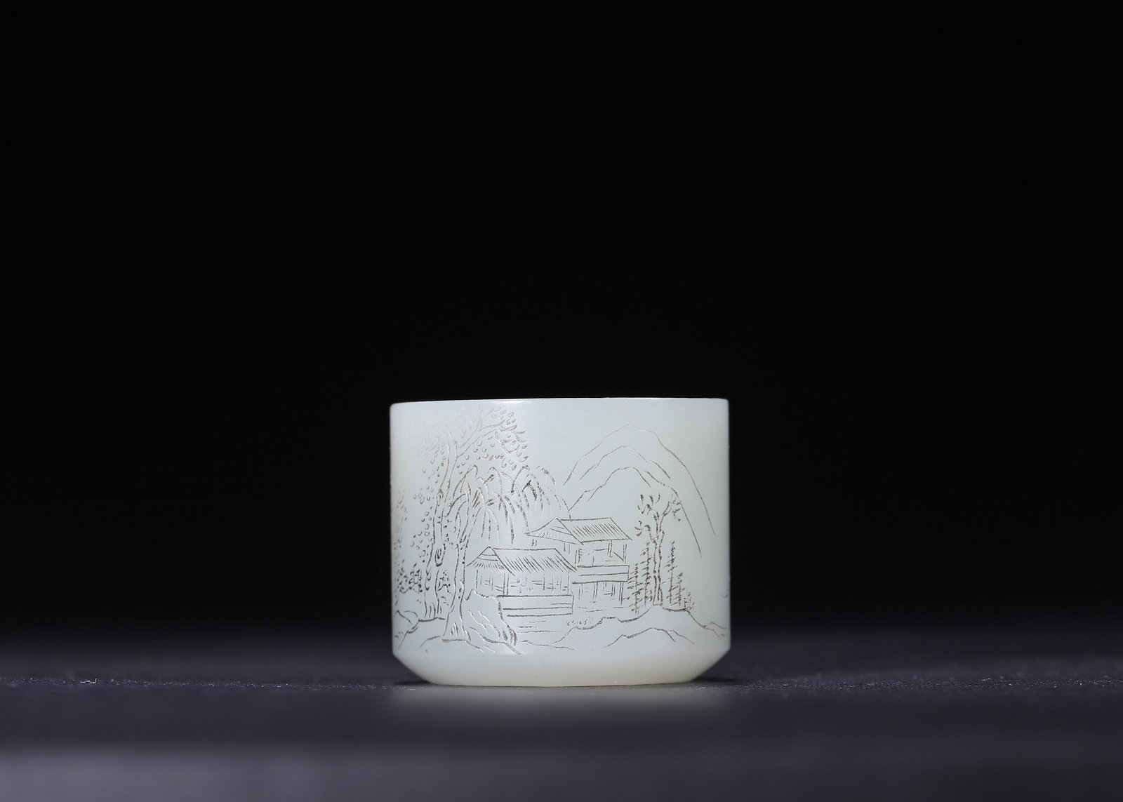 A WHITE HETIAN JADE THUMB RING WITH LANDSCAPE AND POEM, QING DYNASTY: W 2.7cm (1.063 in); Wt 38.00g (0.084 lb);,This Qing Dynasty thumb ring is carved from fine white Hetian jade with silky smooth texture. One side bears delicate shallow carving of mountains, pavilions 