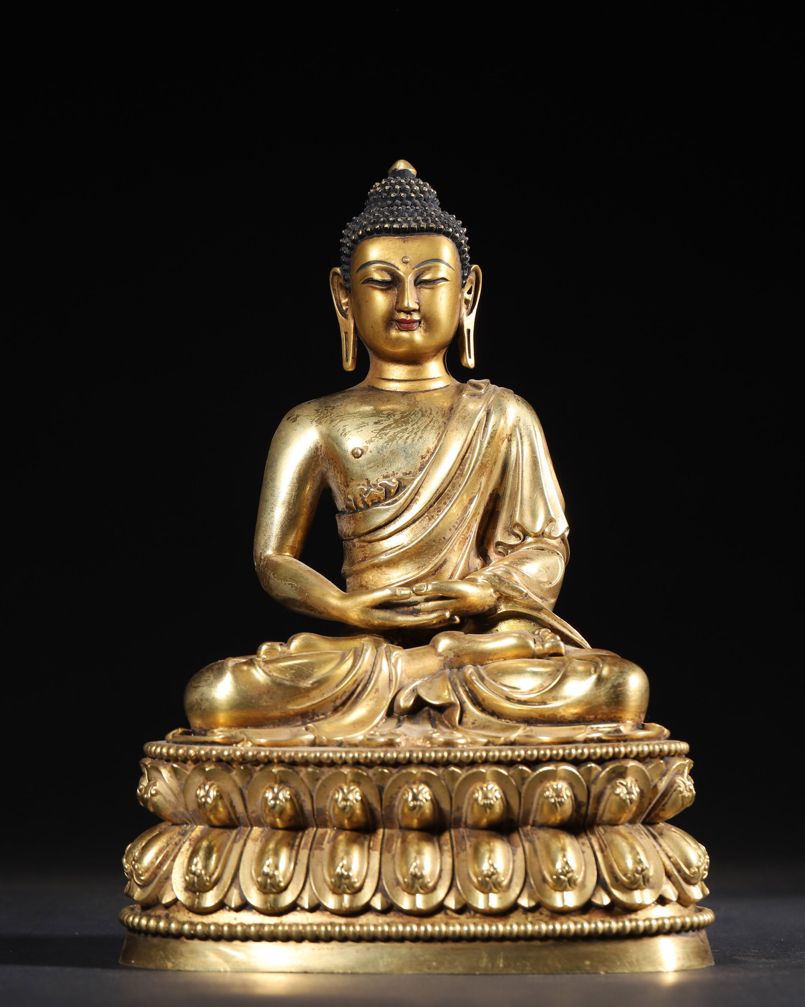 COMMISSIONED GILT-BRONZE FIGURE OF AMITABHA, QING DYNASTY, QIANLONG PERIOD: 5.91" x 4.33" x 8.66" inches (15.0 cm x 11.0 cm x 22.0 cm) (Main) | Weight: 3.22 lbs (1459.0 g)A fine gilt-bronze figure of Amitabha, Qianlong period, Qing Dynasty. Exquisitely cast with rich gilding,