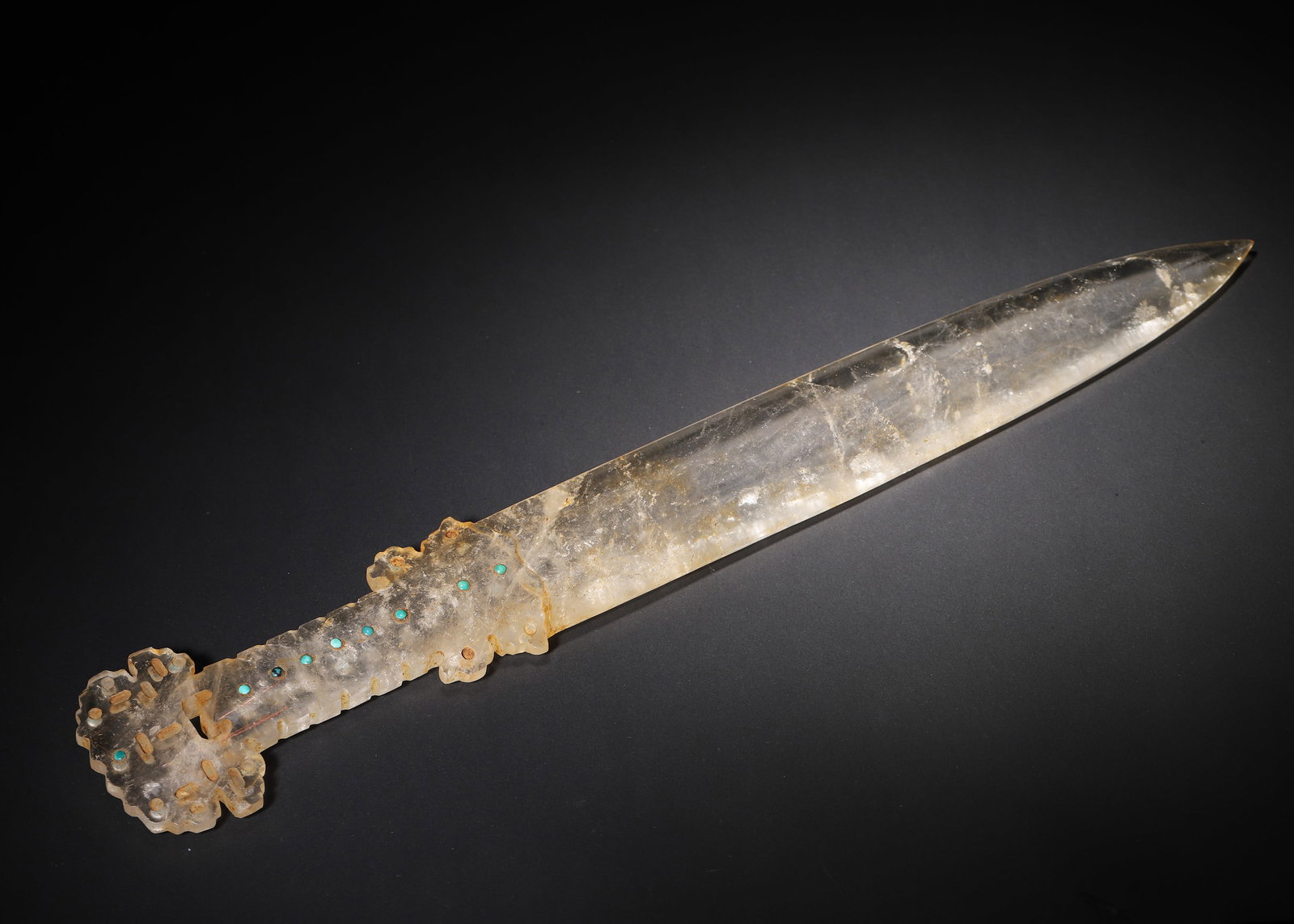 A Turquoise-Inlaid Rock Crystal ornament, Han Dynasty: 48.0 x 7.5 x 7.5 cm (18.9 x 2.95 x 2.95 in), WT 654.0 g (1.44 lb)A Han Dynasty ornament entirely carved from a single piece of natural rock crystal, with natural inclusions and patina from age. The hi