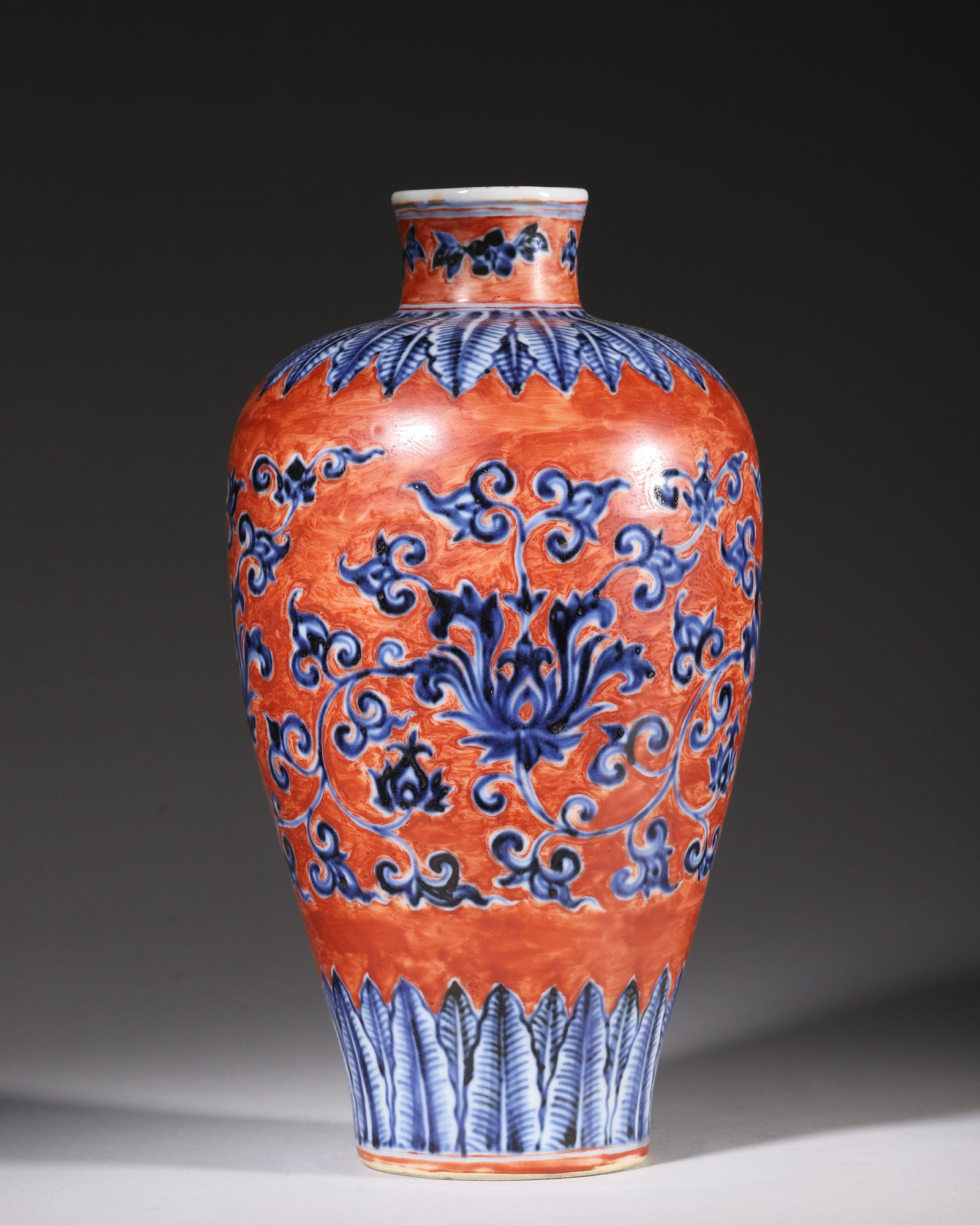 A RED-GROUND BLUE AND WHITE PRUNUS VASE WITH INTERLOCKING LOTUS SCROLLS, XUANDE PERIOD MING DYNASTY (1 of 7)