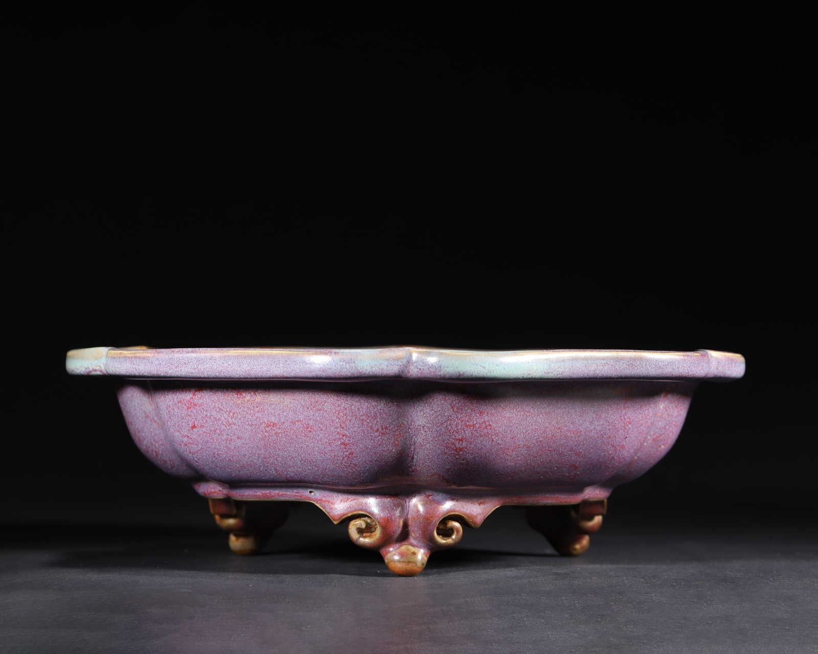NORTHERN SONG DYNASTY: A JUNYAO ROSE-PURPLE GLAZED KUI-SHAPED WASHER WITH THREE FEET: 13.39" x 4.13" inches (34.0 cm x 10.5 cm) (Main)A masterpiece of Northern Song official Jun ware. Kui-shaped mouth, full melon ribs, and three elegant cloud feet. Exterior with rose-purple transmutati