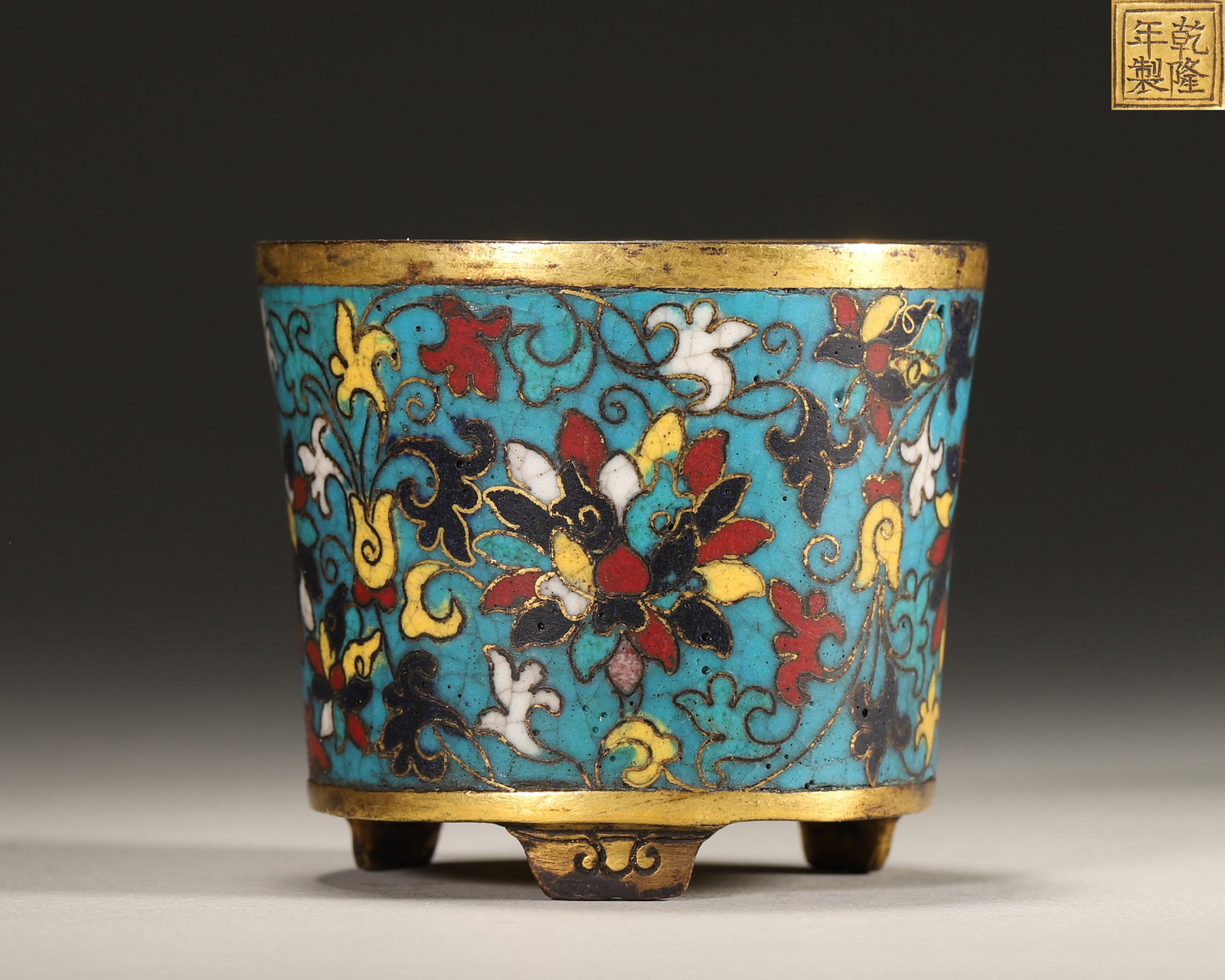 Qing Dynasty, Qianlong Mark, Cloisonne Enamel on Copper Cylindrical Tripod Censer: Diameter 5.8cm (2.28in), Height 5.0cm (1.97in), Weight 104.0g (0.23lb)Imperially made by the Imperial Workshop. The censer body uses blue as the background, fully decorated with interlocking branch fl
