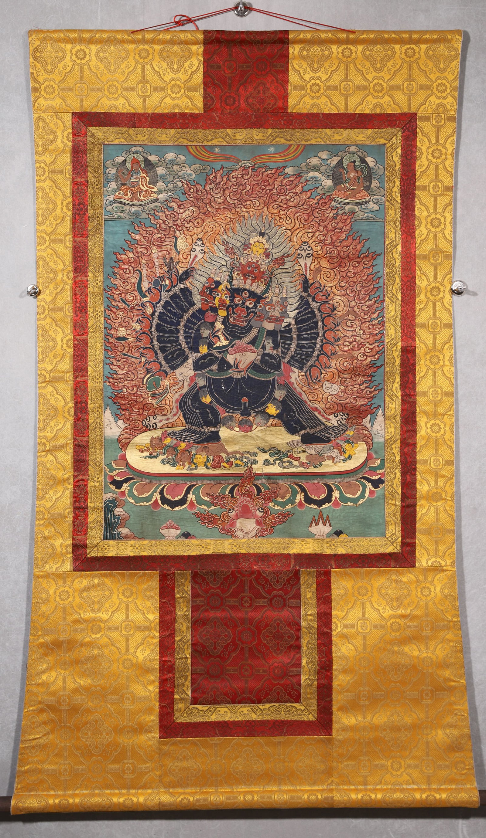 A Yamantaka Thangka - Qing Dynasty: Length 78.0cm (30.71in), Width 56.0cm (22.05in)This Qing Dynasty thangka depicts Yamantaka, painted with mineral pigments on cotton. The central wrathful deity stands amid flames, surrounded by Buddha