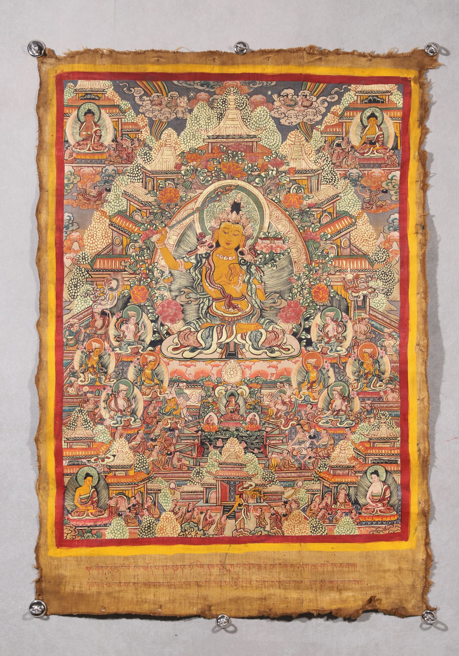 A Manjushri Bodhisattva Thangka - Qing Dynasty: Length 88.0cm (34.65in), Width 66.0cm (25.98in)This Qing Dynasty thangka depicts Manjushri Bodhisattva, painted with mineral pigments on cotton. Seated at the center, Manjushri holds a wisdom sword an