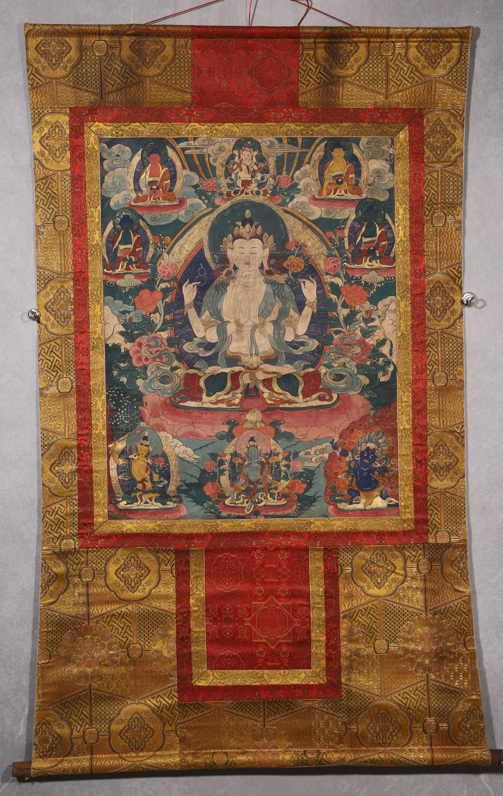 A Four-armed Avalokiteshvara Thangka - Qing Dynasty: Length 78.0cm (30.71in), Width 60.0cm (23.62in)This Qing Dynasty thangka depicts Four-armed Avalokiteshvara, painted with mineral pigments on cotton. The compassionate Bodhisattva sits on a lotus thro