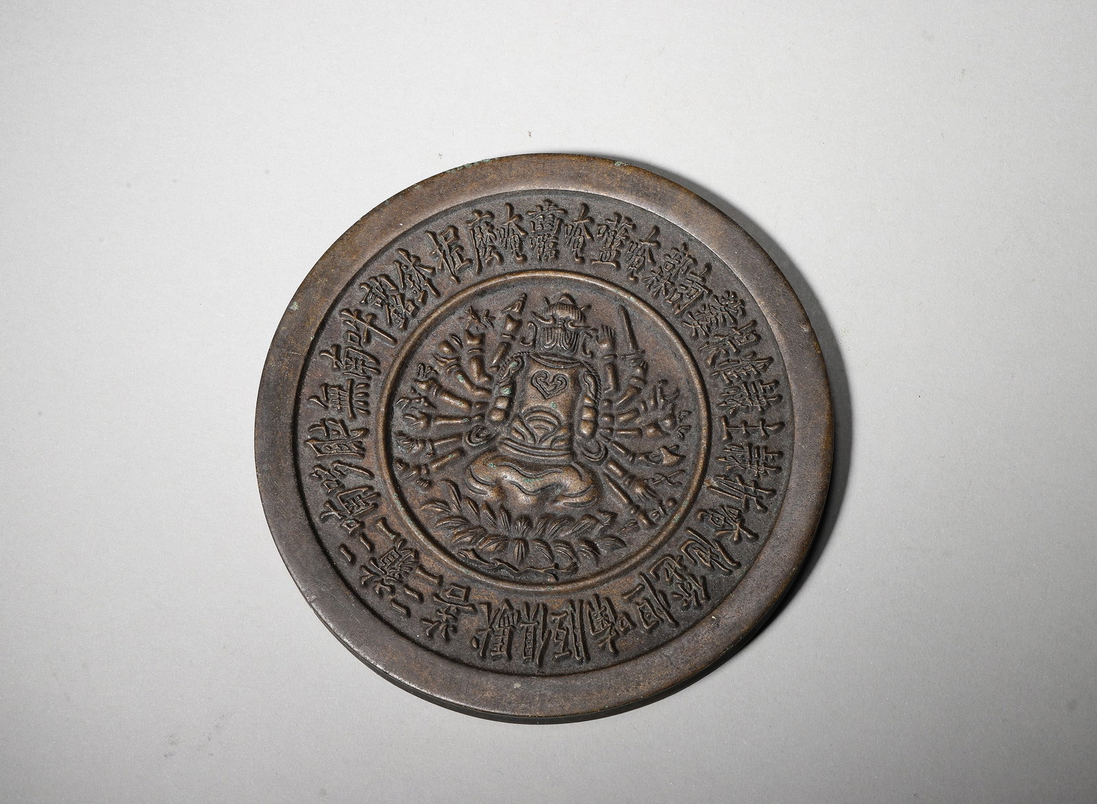 A BRONZE MIRROR WITH CUNDI BODHISATTVA AND MANTRA INSCRIPTION, MING DYNASTY (1 of 4)