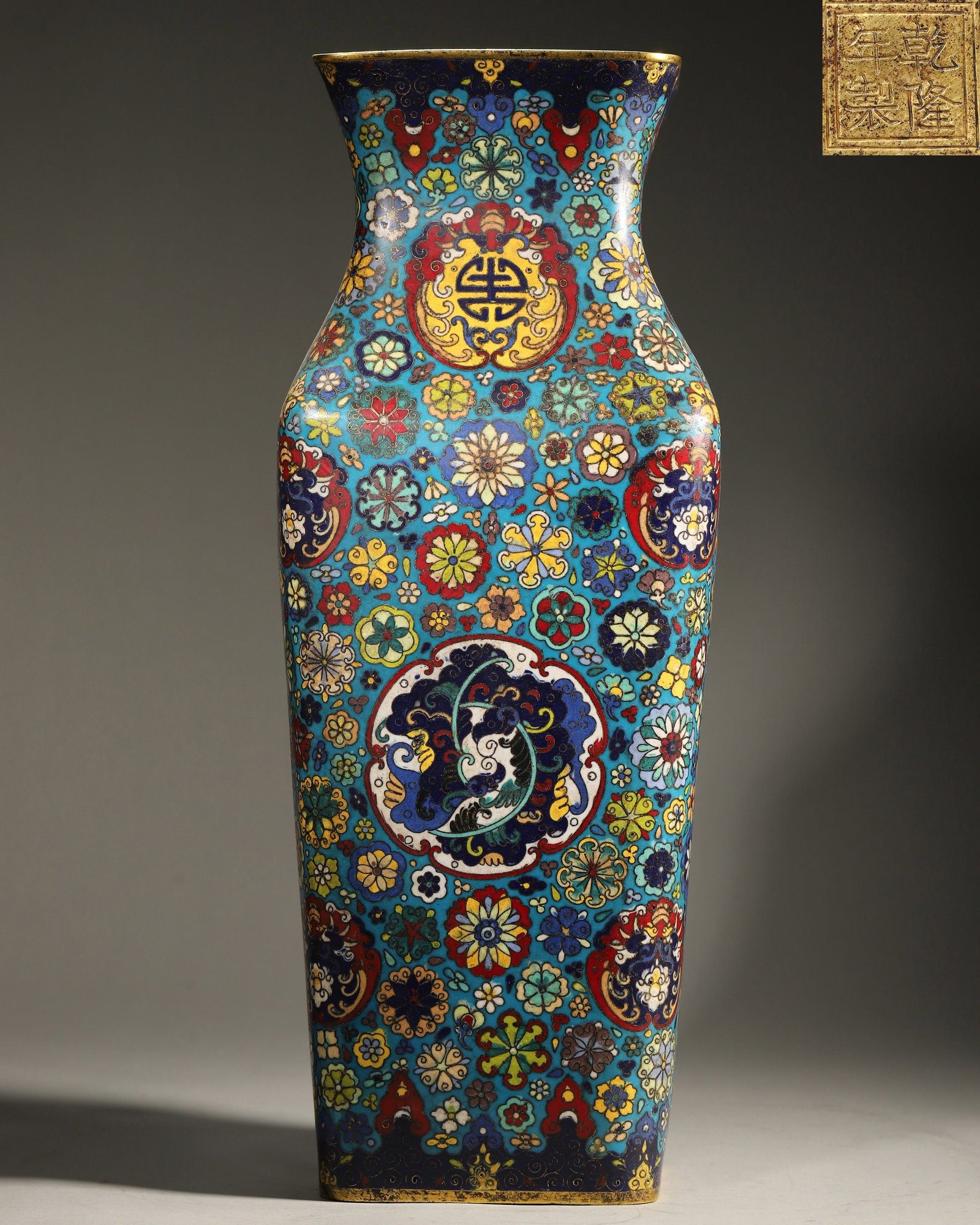 Qing Dynasty, Qianlong Mark, Cloisonne Enamel on Copper Rectangular Vase: Width 18.0cm (7.09in), Height 47.5cm (18.7in), Weight 4883.0g (10.77lb)Made by the Imperial Workshop. The vase body is fully decorated with hundreds of flowers pattern, longevity characters, and auspi