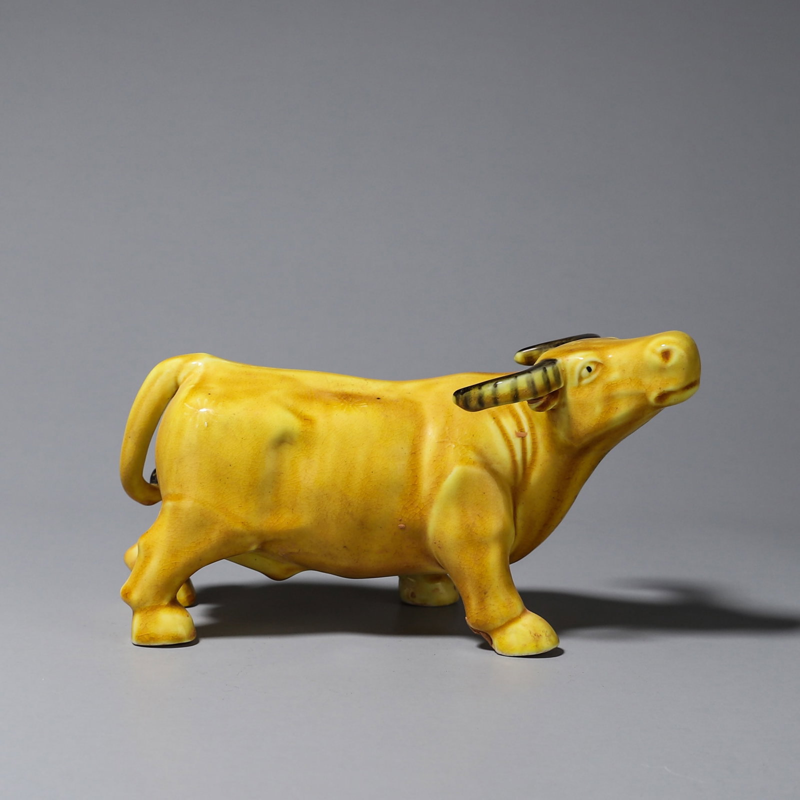 Qing Dynasty, Yellow Glazed Porcelain Sculpture of Auspicious Ox: L: 16cm (6.30in) W: 6cm (2.36in) H: 9cm (3.54in) WT: 350g