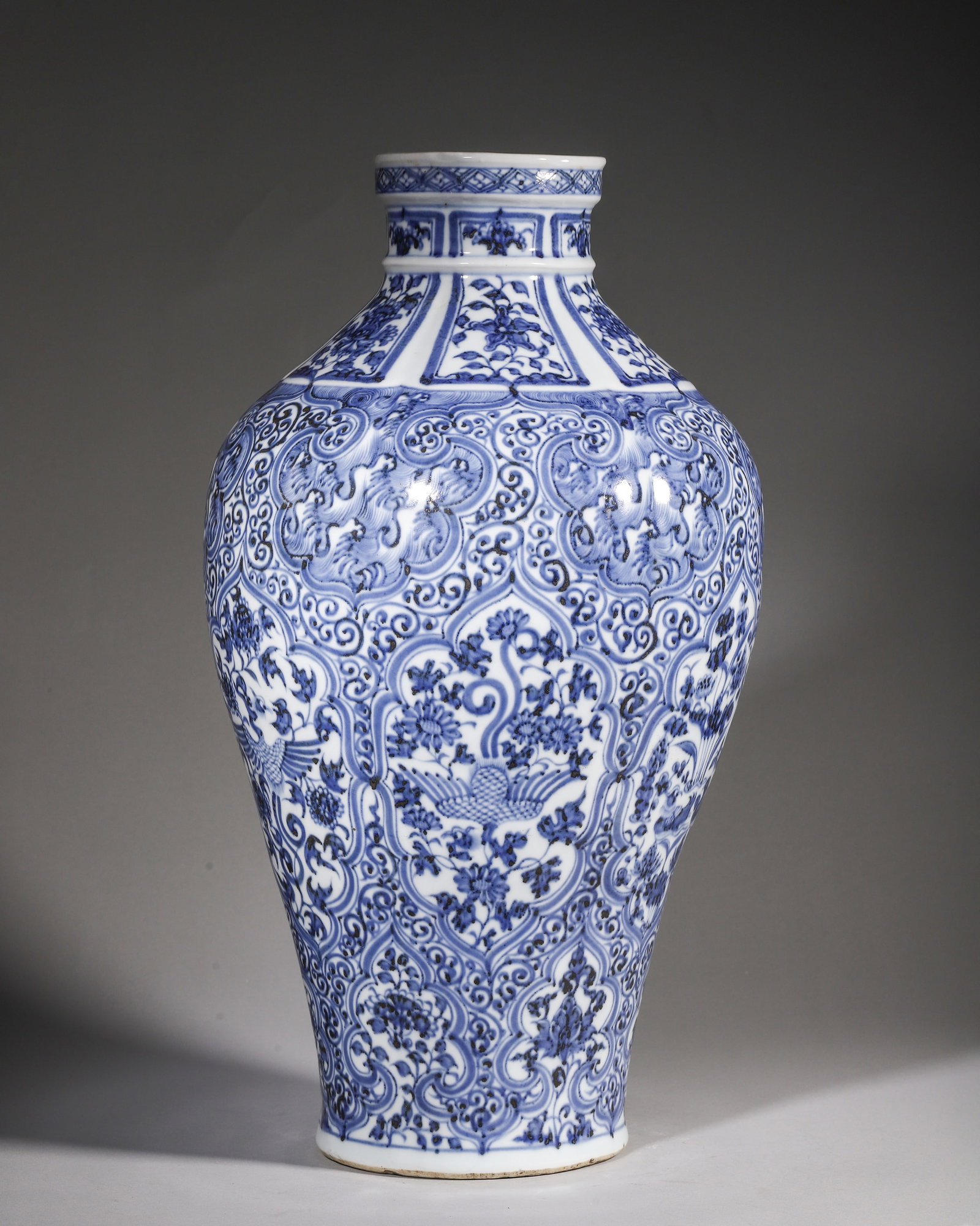 A BLUE AND WHITE PRUNUS VASE WITH PHOENIX, MANDARIN DUCK AND FLORAL PANELS ON WAVE GROUND, YUAN: L 25cm (9.84 in); H 48cm (18.9 in),Yuan blue and white prunus vase with sand base, decorated with rhombus border at rim and floral panels on neck. Whole body covered with scroll wave ground divided by