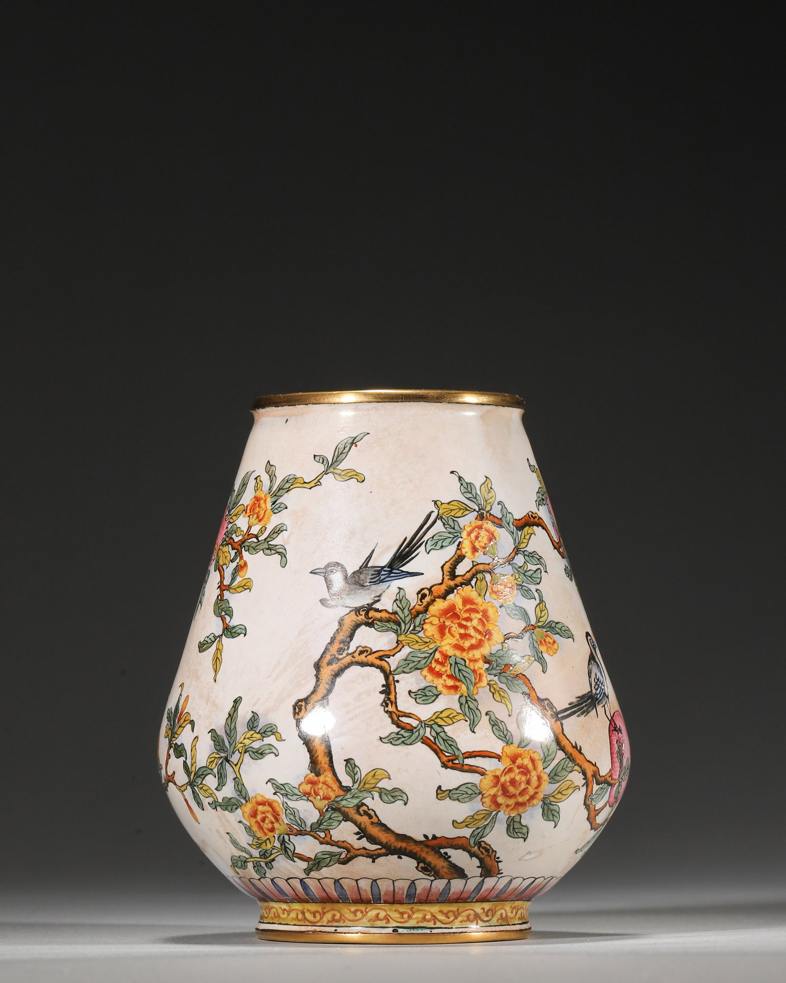 QIANLONG PERIOD, QING DYNASTY COPPER-BODIED ENAMEL VASE WITH BIRD AND FLOWER MOTIFS: 3.15in (8.0cm), 0.736lb (334.0g)A fine Qianlong period copper enamel vase with white ground, delicate pomegranate, camellia and magpie motifs, and gilt rims. Marked "Qianlong Nian Zhi", it exemplifies