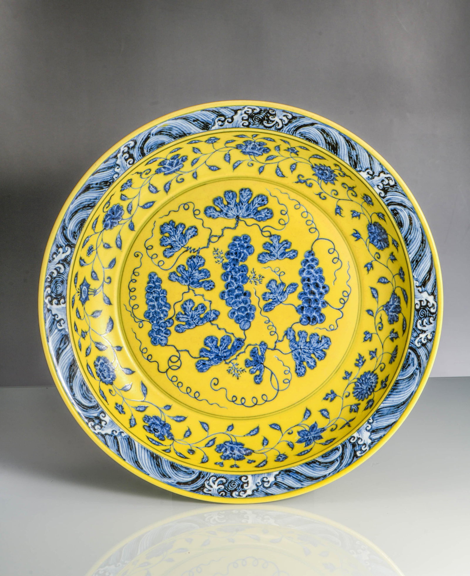 A yellow-ground blue and white 'Interlocking grapes' dish: A YELLOW-GROUND BLUE AND WHITE 'INTERLOCKING GRAPES' DISH Description: Width:37.5cm, Height:6cm
