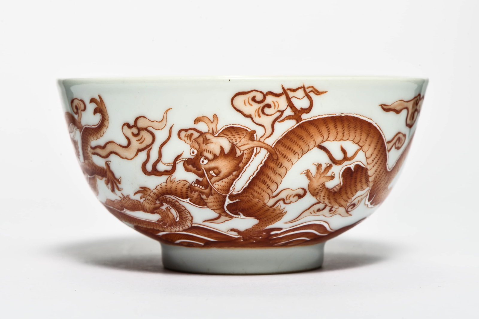An iron-red 'Dragon' bowl: AN IRON-RED 'DRAGON' BOWL Description: Diameter: 15cm Height: 7cm