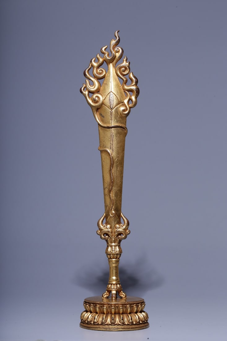 A Gilt Bronze Manjushri Wisdom Sword: A Gilt Bronze Manjushri Wisdom Sword. Height: 9.25in Diameter: 2.09in; Weight: 306g.