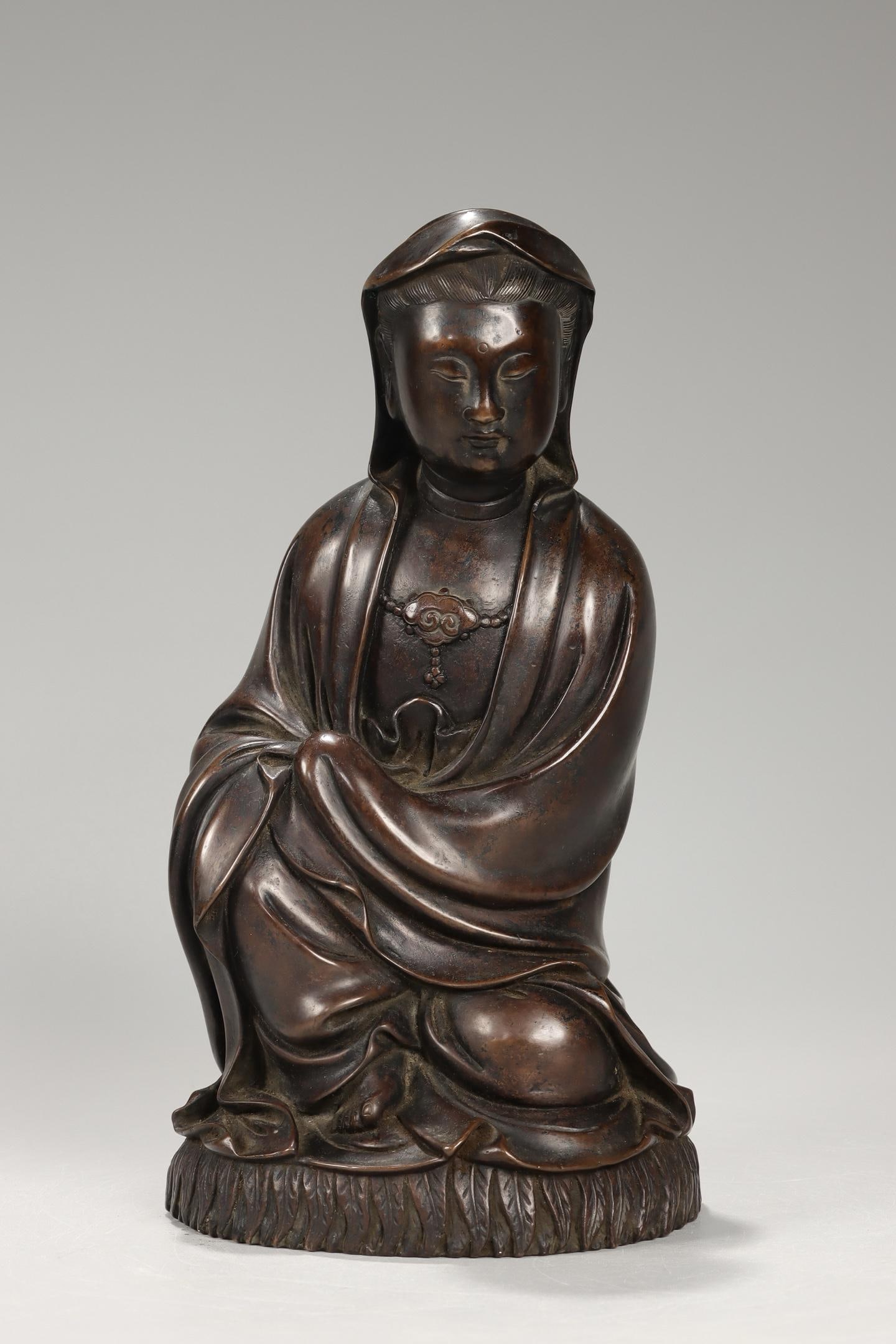A Bronze Seated Guanyin Statue: A Bronze Seated Guanyin Statue. Height: 8.86in Width: 4.61in; Weight: 5.13lbs.