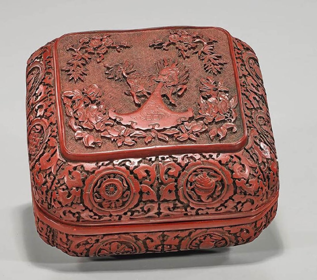 Chinese Cinnabar Lacquer Box: Chinese cinnabar lacquer covered box; centering a qilin framed by Buddhist and floral motifs; mark to base; L: 9 1/2" (approx.)