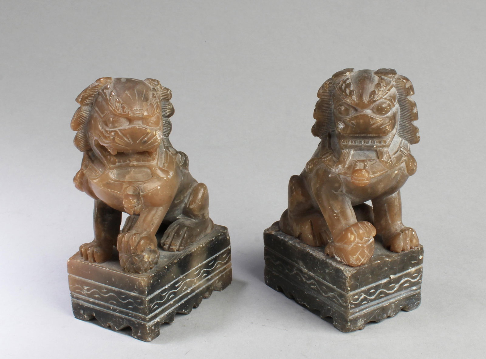 A Pair of Soapstone Foo Lion Display: A Pair of Soapstone Foo Lion Display. Length: 2.25" Width: 2" Height: 4"