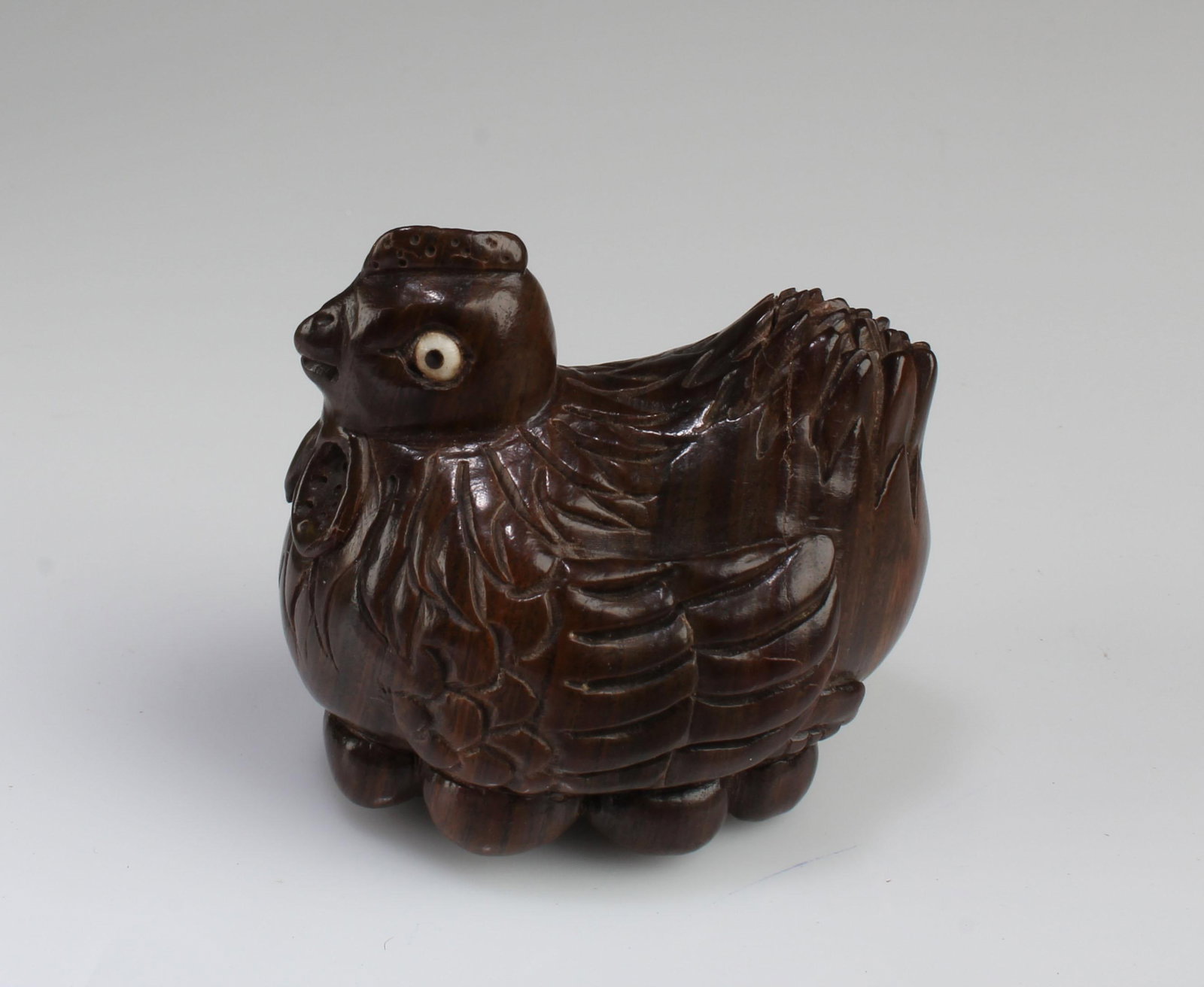 A Carved Wooden Hen Figurine: A Carved Wooden Hen Figurine. Length: 1.75"