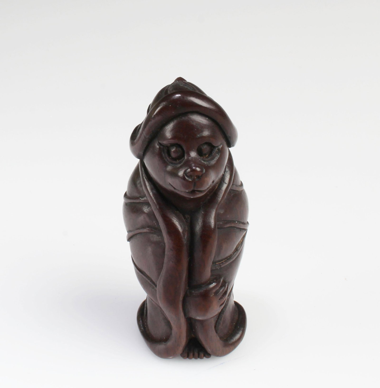 A Carved Wooden Figurine: A Carved Wooden Figurine. Height: 2"