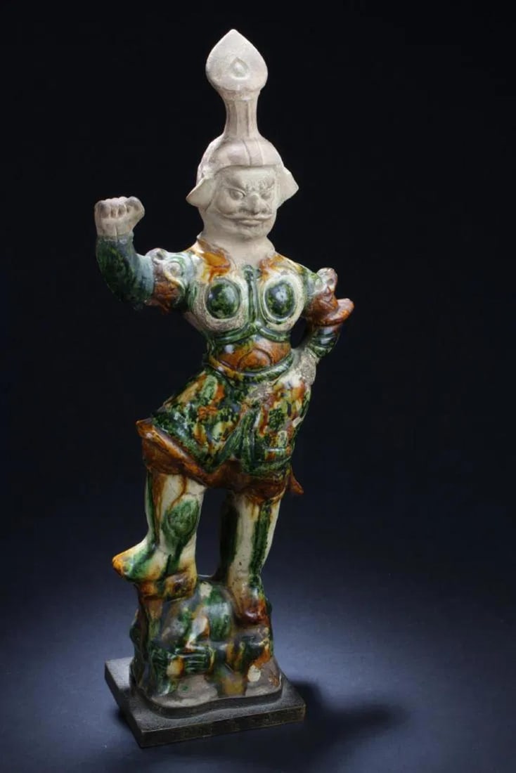 Antique Chinese Pottery 'Tang San Cai' Statue: Antique Chinese Pottery Statue, depicting a warrior in armour suit and headdress with right hand raised. Comes fitted with a stand. Height: 20 "Provenance: An item from a museum in America.