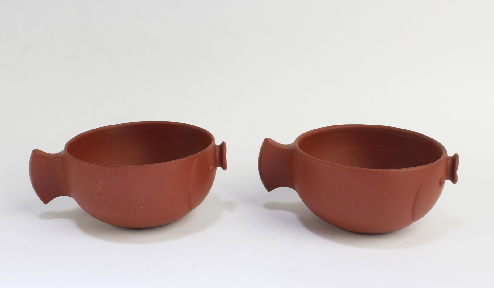 A Pair of Zisha Cups: A Pair of Zisha Cups. Length: 3.75" Height: 1.5"