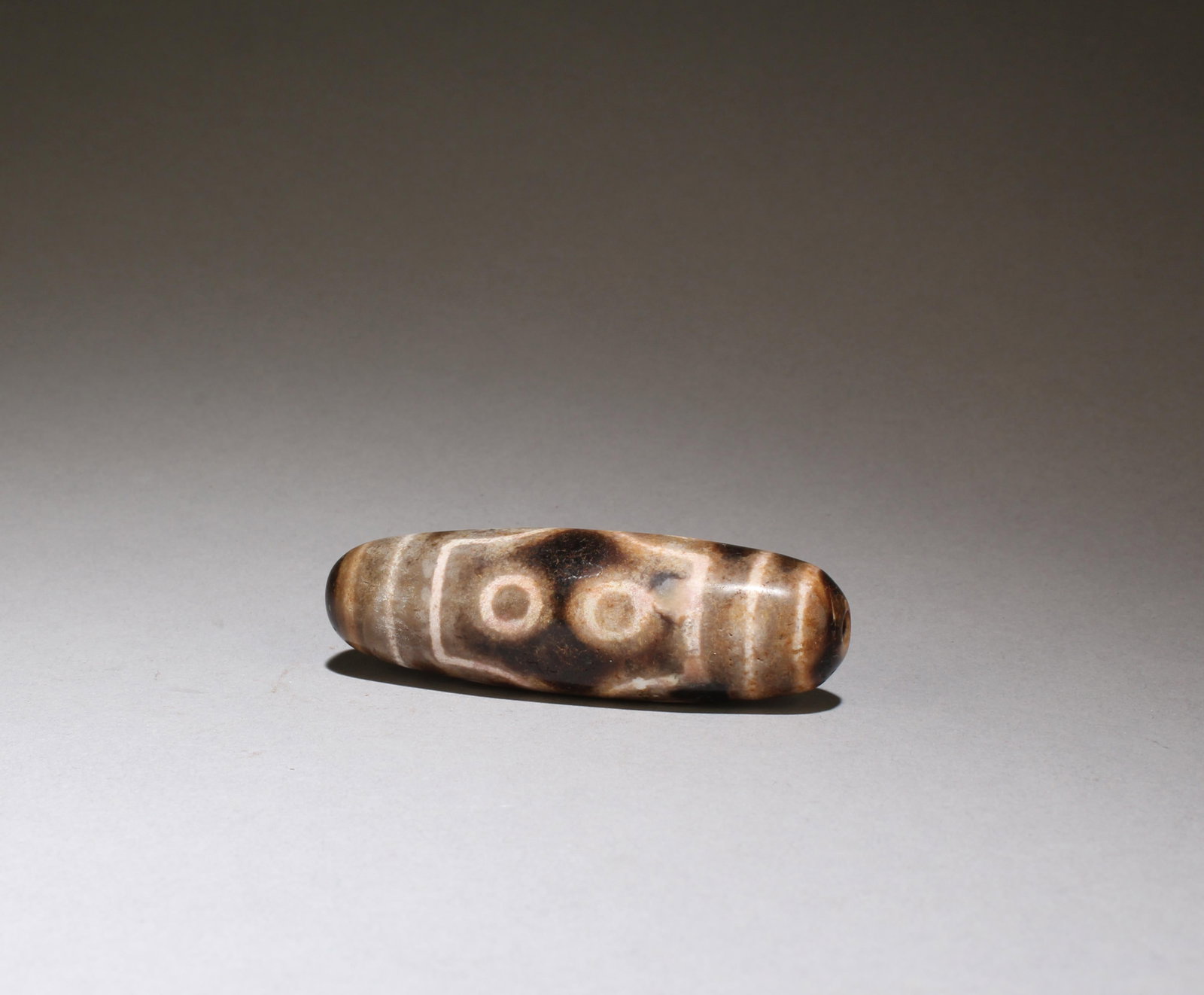 A Dzi Bead: A Dzi Bead. Length: 2.5"