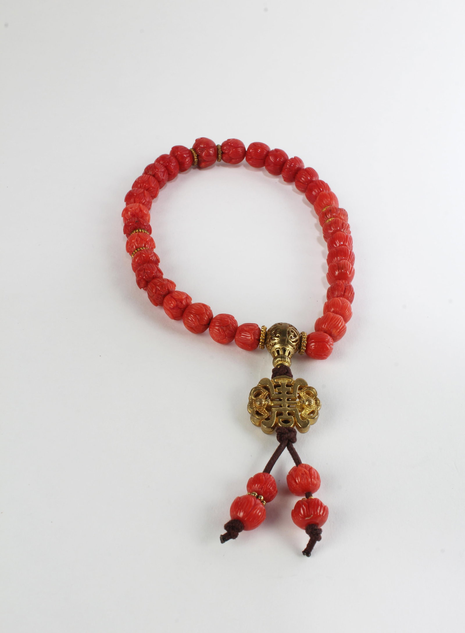 A Coral Beaded Prayer Bracelet: A Coral Beaded Prayer Bracelet, 32 beads. Diameter: 0.25 (largest bead)