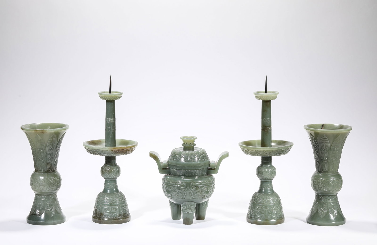 A Jade 'Carved Taotie' Five Offerings: A Jade 'Carved Taotie' Five Offerings. Dimensions: Length: 6.34" x Width: 4.25" x Height: 6.69". Width: 4.37" x Height: 11.81". Width: 3.82" x Height: 7.72". All measurements are approximate.