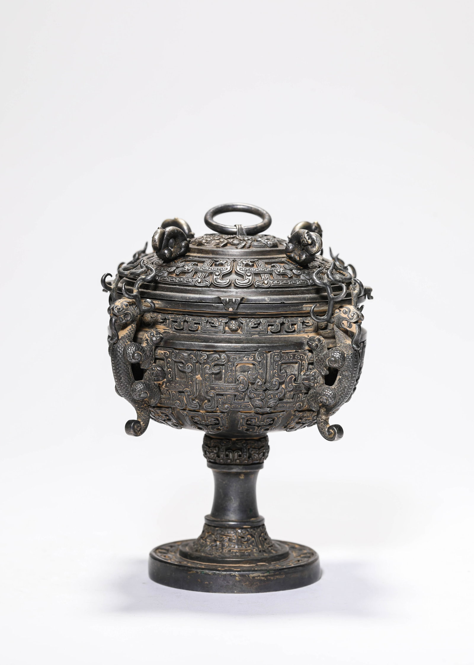A Bronze 'Taotie and Dragon' Dou: A Bronze 'Taotie and Dragon' Dou. Dimensions: Weight: 813 g. Length: 5.35" x Width: 4.13". All measurements are approximate. (Zhu :Gao Du Shu Ju Que Shi )
