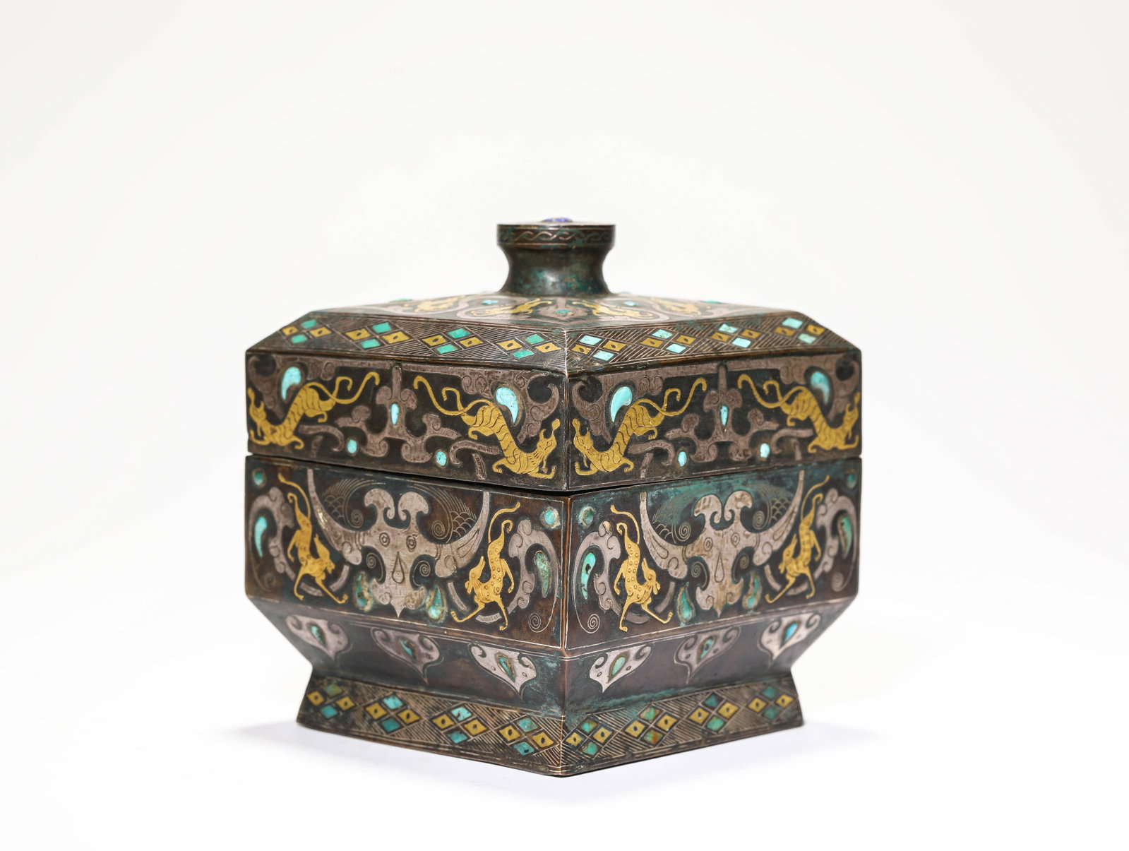 A Gold and Silver-Inlaid Bronze 'Animal Mask' Covered Box: A Gold and Silver-Inlaid Bronze 'Animal Mask' Covered Box. Dimensions: Weight: 1750 g. Width: 4.92" x Height: 5.59". All measurements are approximate.
