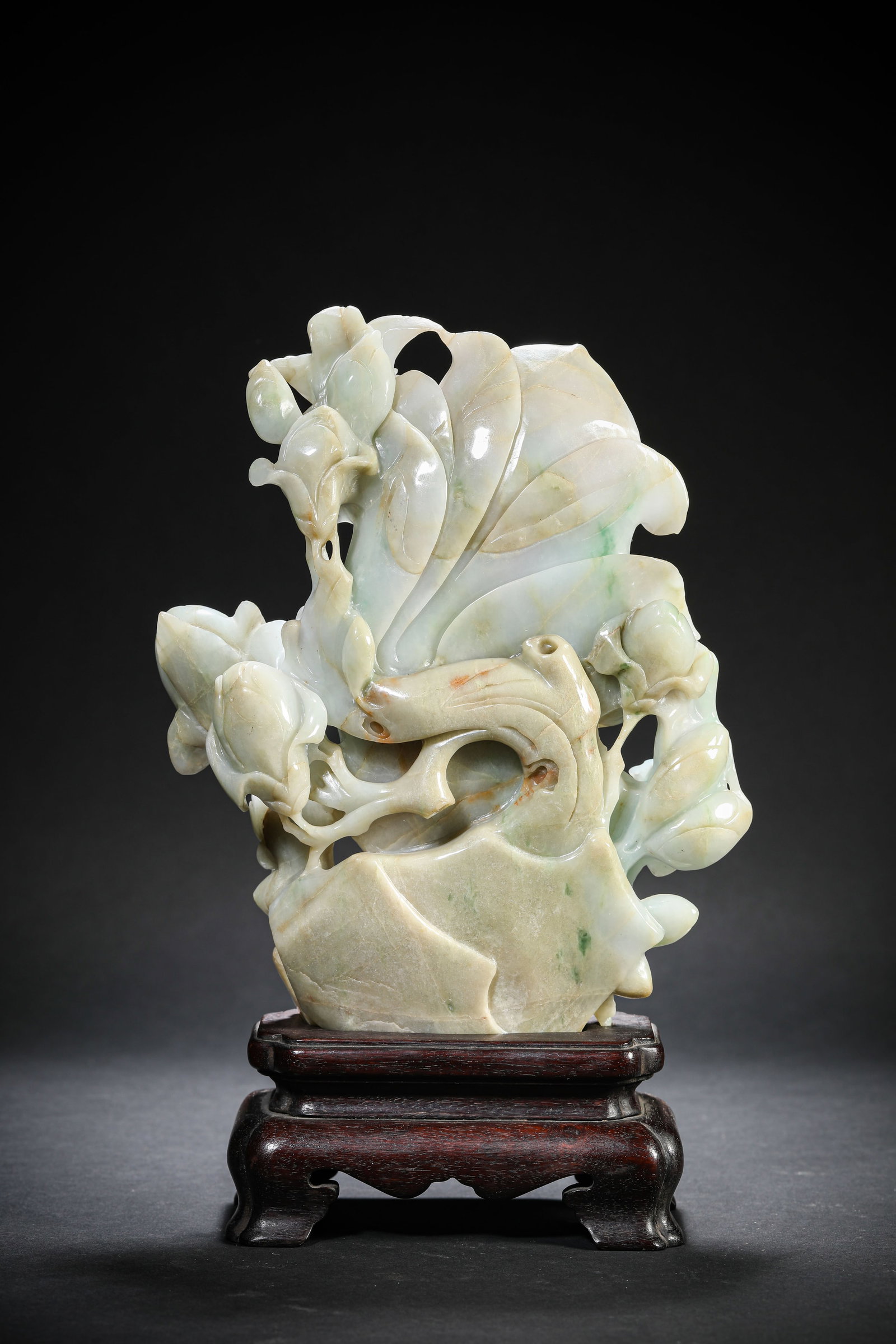 A Jadeite 'Carved Floral' Ornament: A Jadeite 'Carved Floral' Ornament. Dimensions: Length: 6.69" x Width: 1.93" x Height: 10.55". All measurements are approximate.