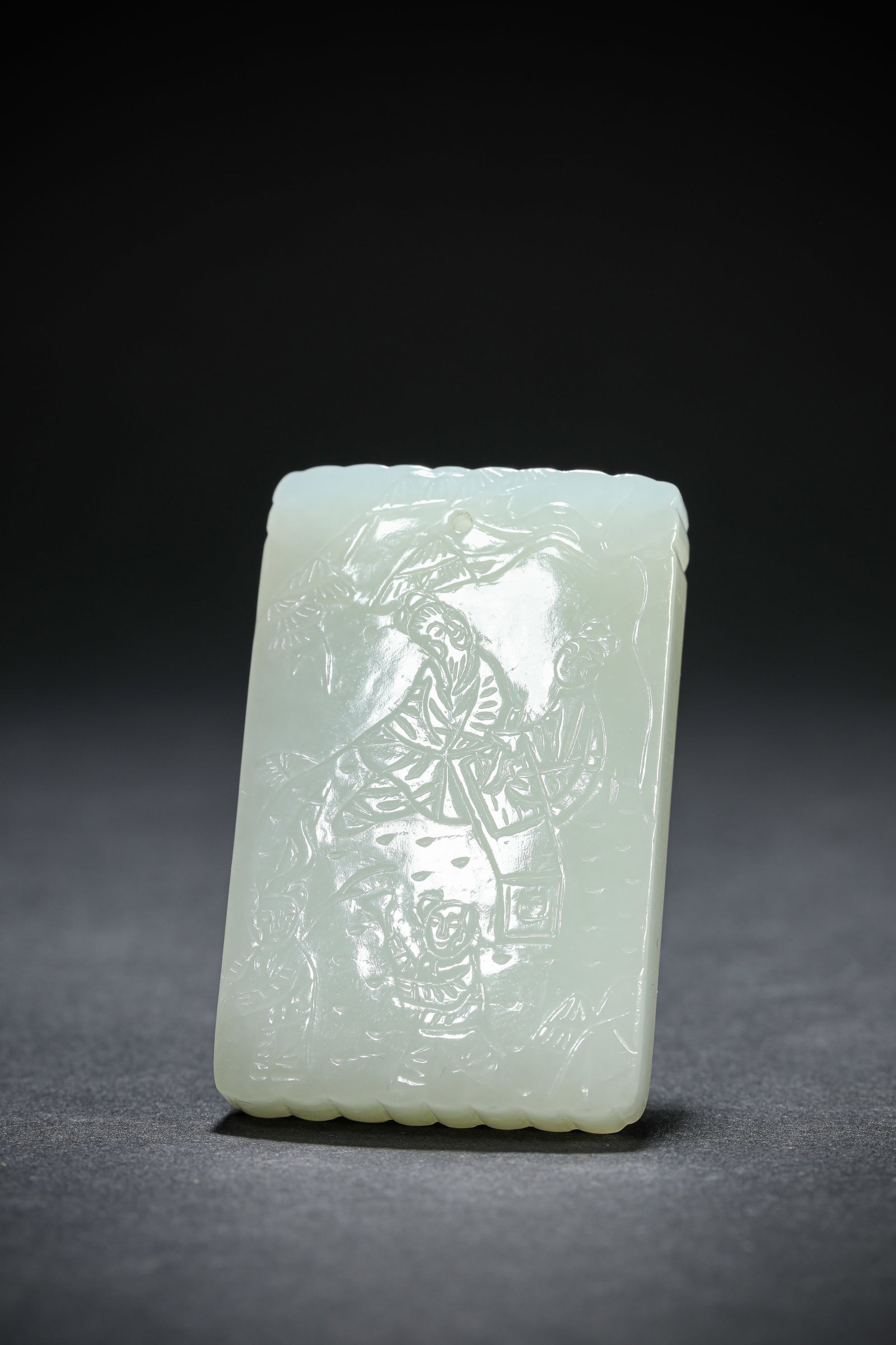 A Jade 'Carved Figure and Poem' Plaque: A Jade 'Carved Figure and Poem' Plaque. Dimensions: Width: 1.38" x Height: 2.13". All measurements are approximate.