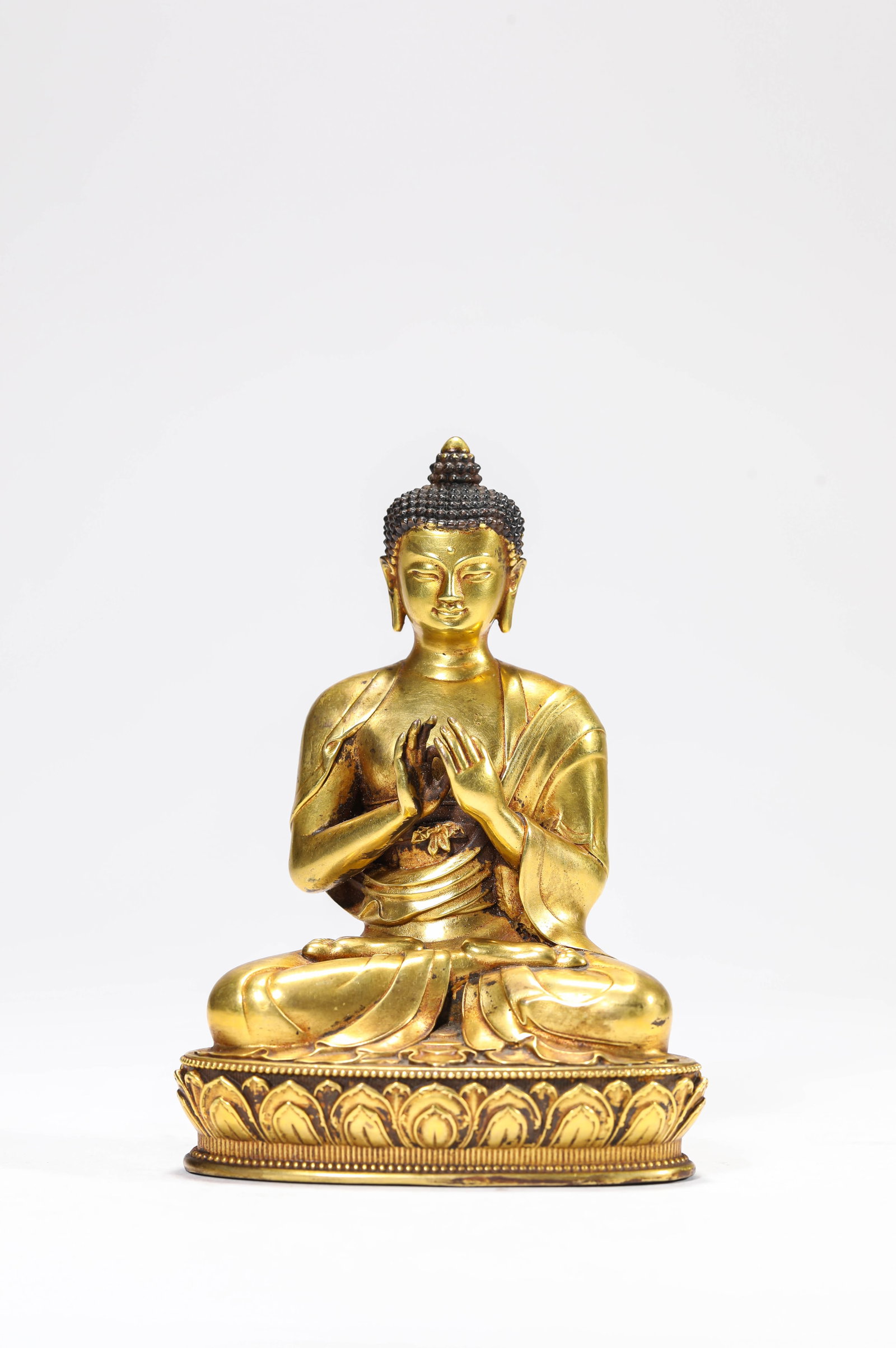 A Gilt-Bronze Figure of Shakyamuni: A Gilt-Bronze Figure of Shakyamuni. Dimensions: Weight: 719 g. Length: 3.07" x Width: 2.01" x Height: 4.29". All measurements are approximate.