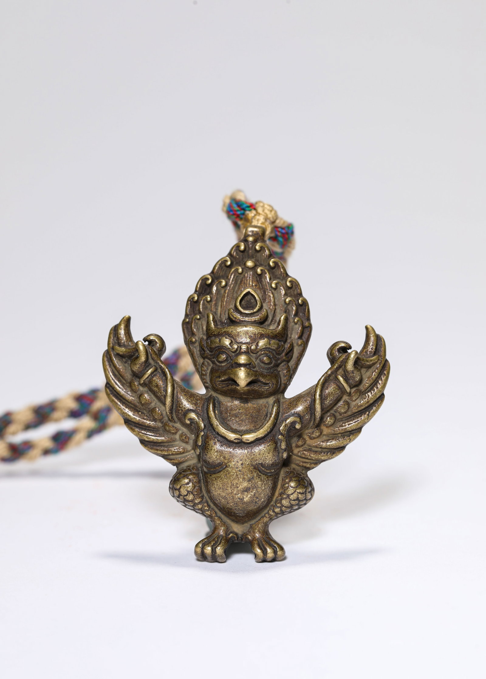 A Bronze Garuda: A Bronze Garuda. Dimensions: Weight: 38 g. Width: 2.01" x Height: 2.40". All measurements are approximate.
