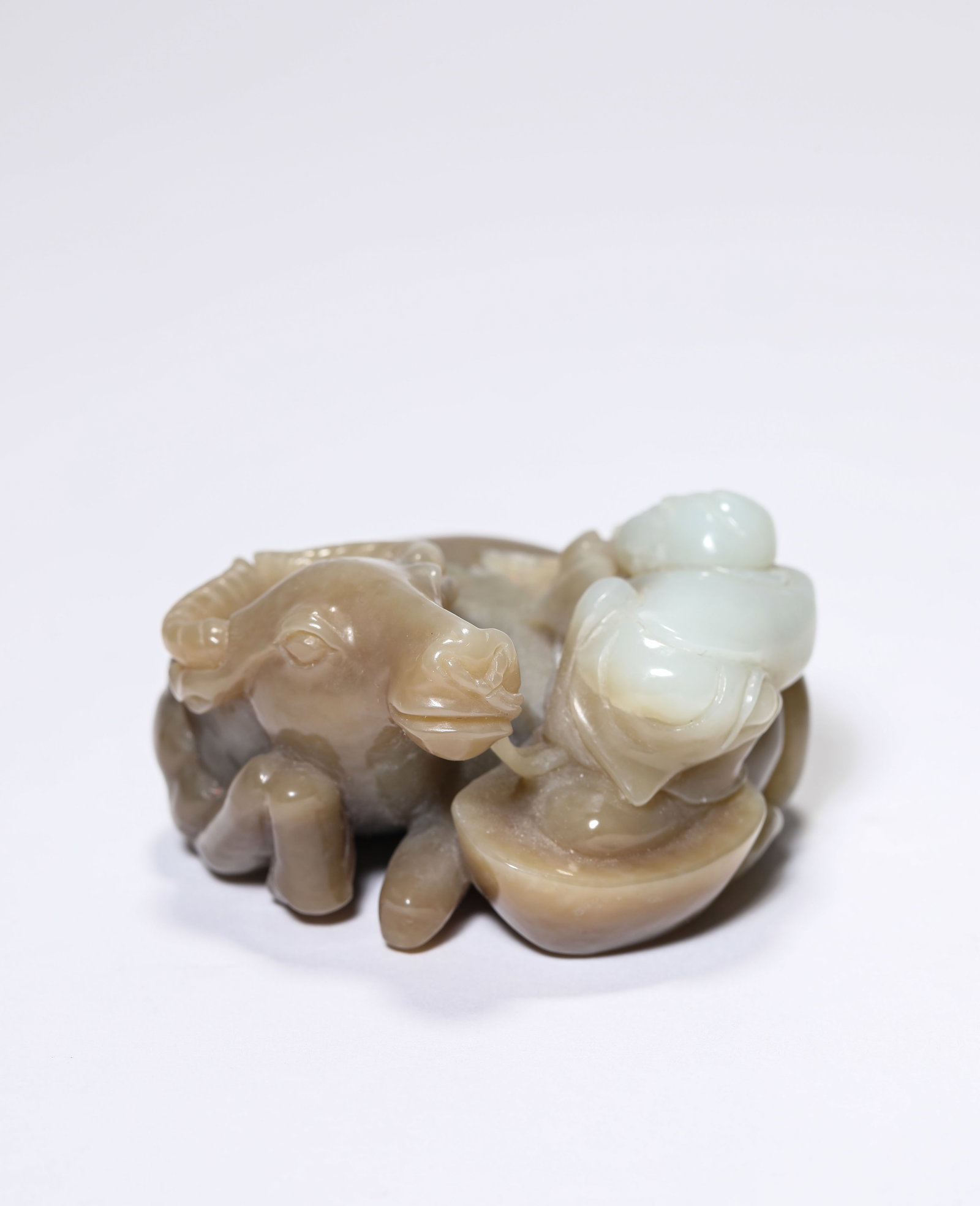 A Jade 'Carved Boy Herding a Buffalo': A Jade 'Carved Boy Herding a Buffalo'. Dimensions: Length: 2.20" x Width: 2.17" x Height: 1.18". All measurements are approximate.