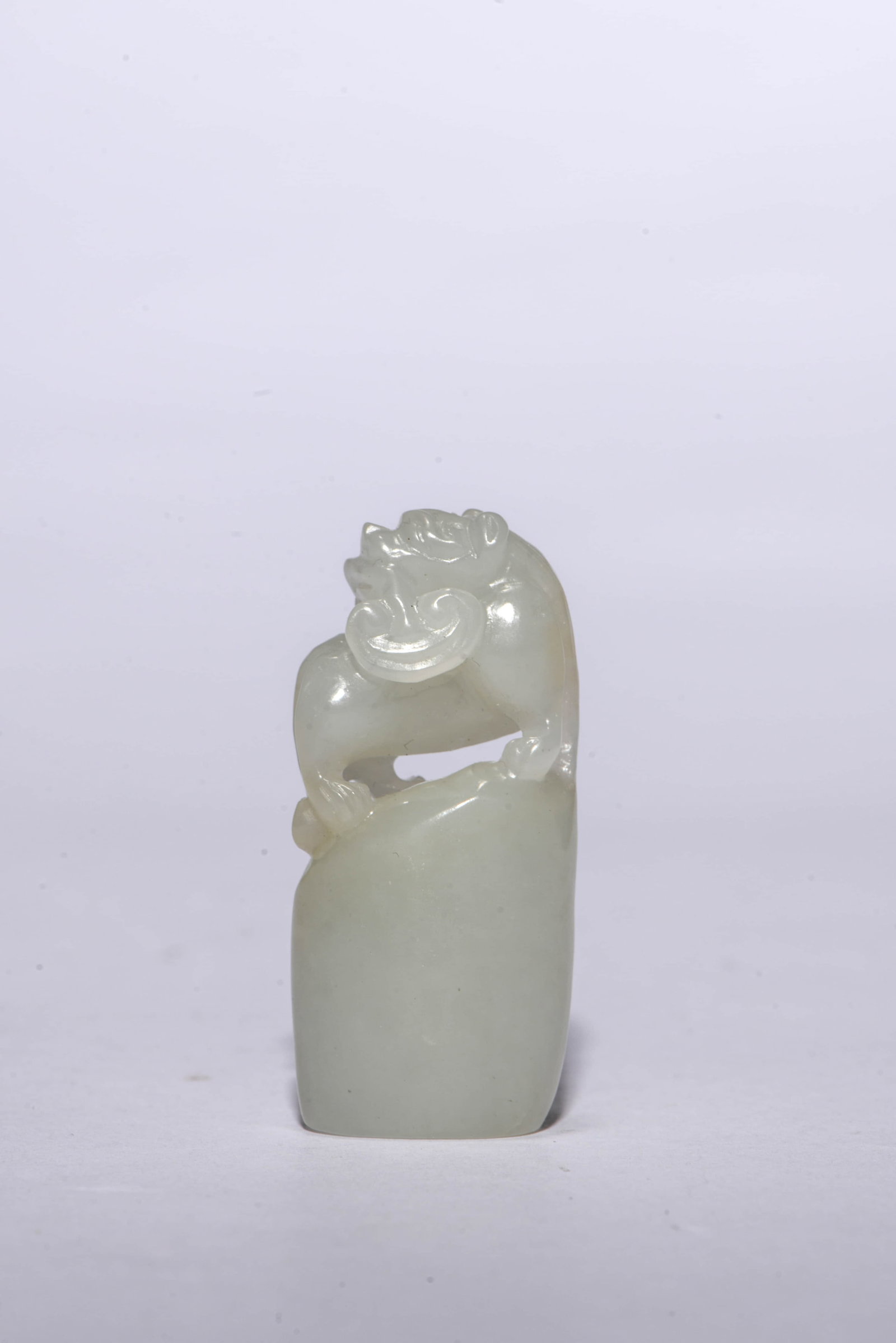 A Hetian Jade 'Beast-Form Finial' Seal: A Hetian Jade 'Beast-Form Finial' Seal. Dimensions: Width: 0.94" x Height: 0.51". All measurements are approximate.