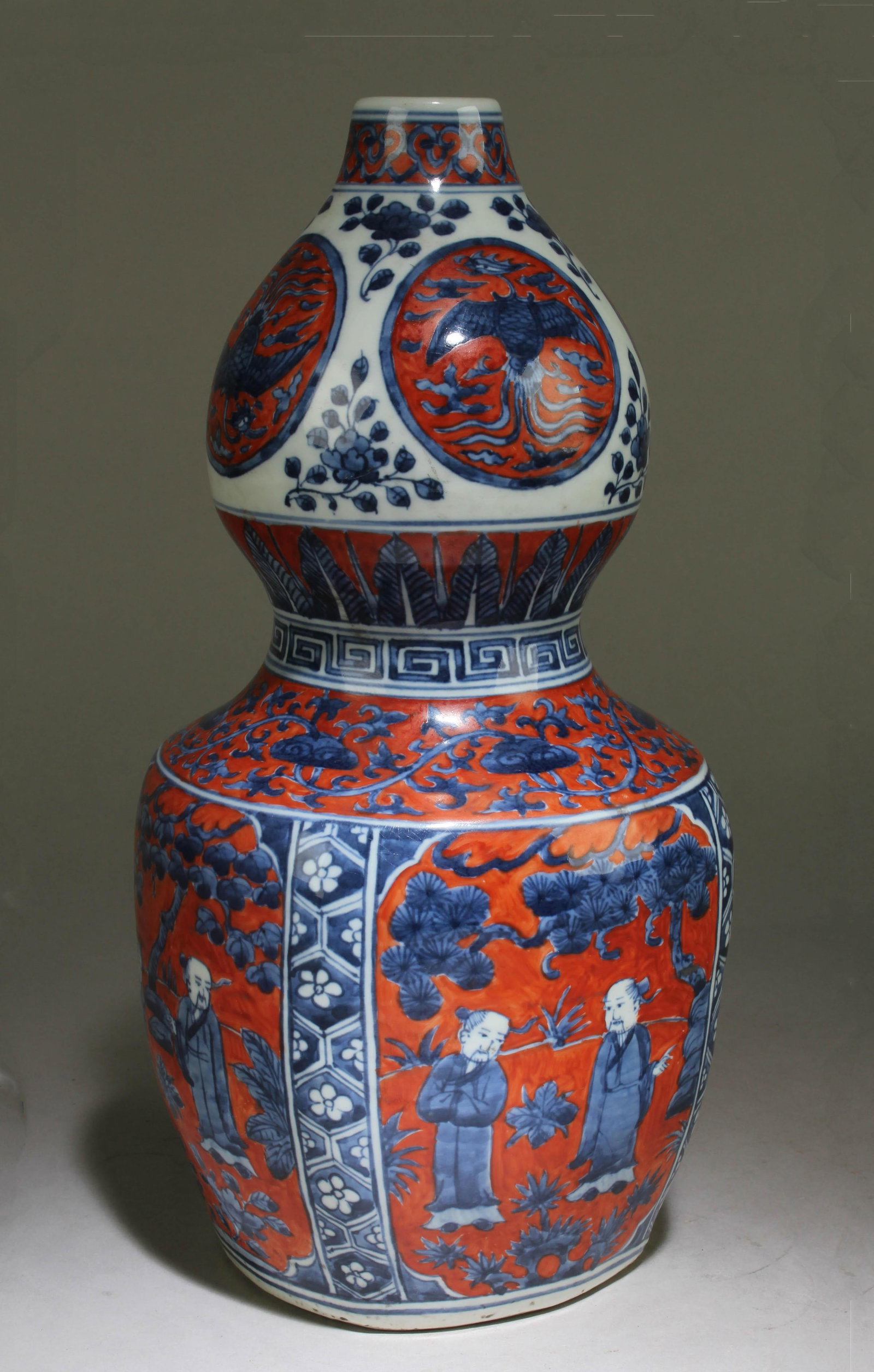 A Chinese Blue and White Vase: A Chinese Blue and White Vase with a Red Background. Dimension: 13" x 6.5".