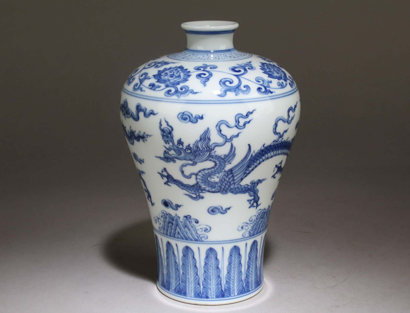 A Blue and White Chinese Vase with a Dragon Design: A Blue and White Chinese Vase with a Dragon Design. Dimension: 8" x 5.5".