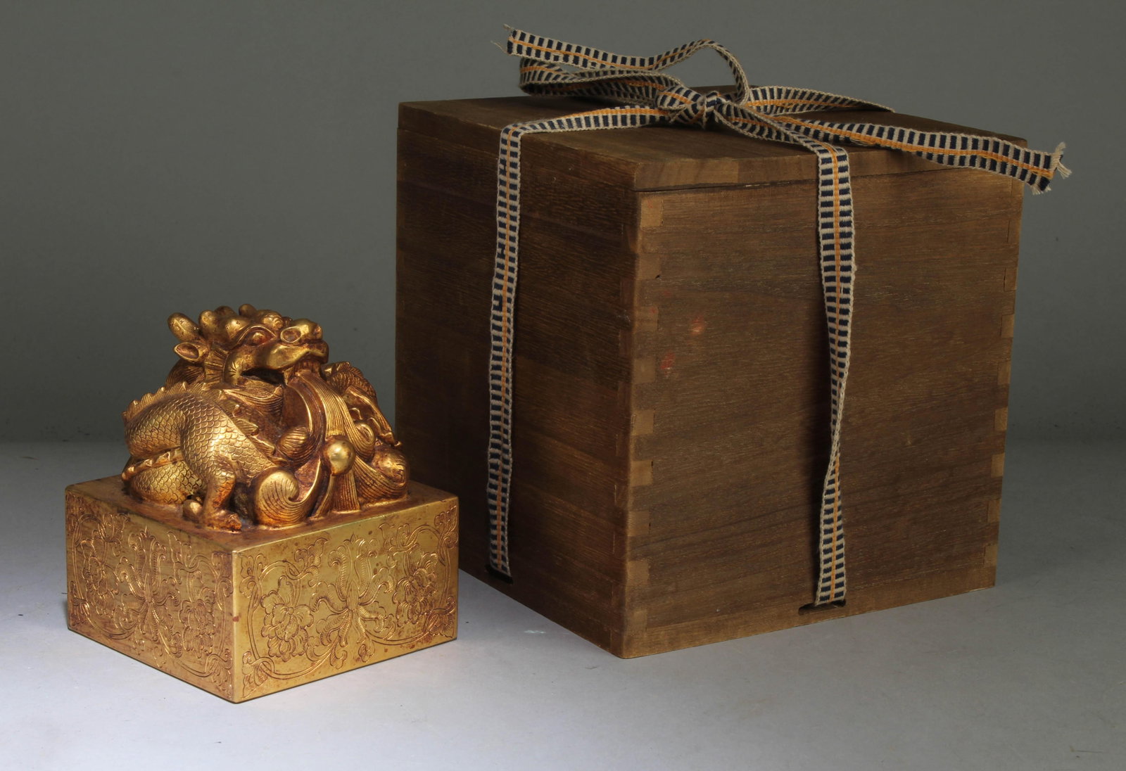A Chinese Gilt Bronze Dragon Shaped Seal: A Chinese Gilt Bronze Dragon Shaped Seal. Dimension: 4.3" x 3.6".