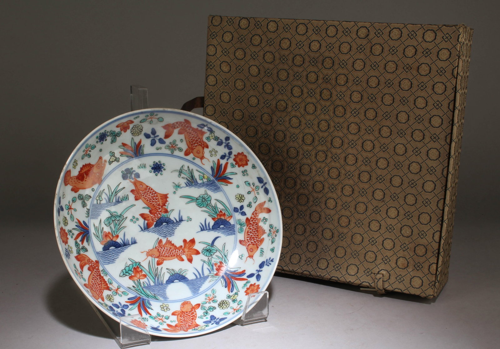 A Chinese WuCai Saucer-Dish with a Koi Fish Design: A Chinese WuCai Saucer-Dish with a Koi Fish Design. Dimension: 2" x 8.6".